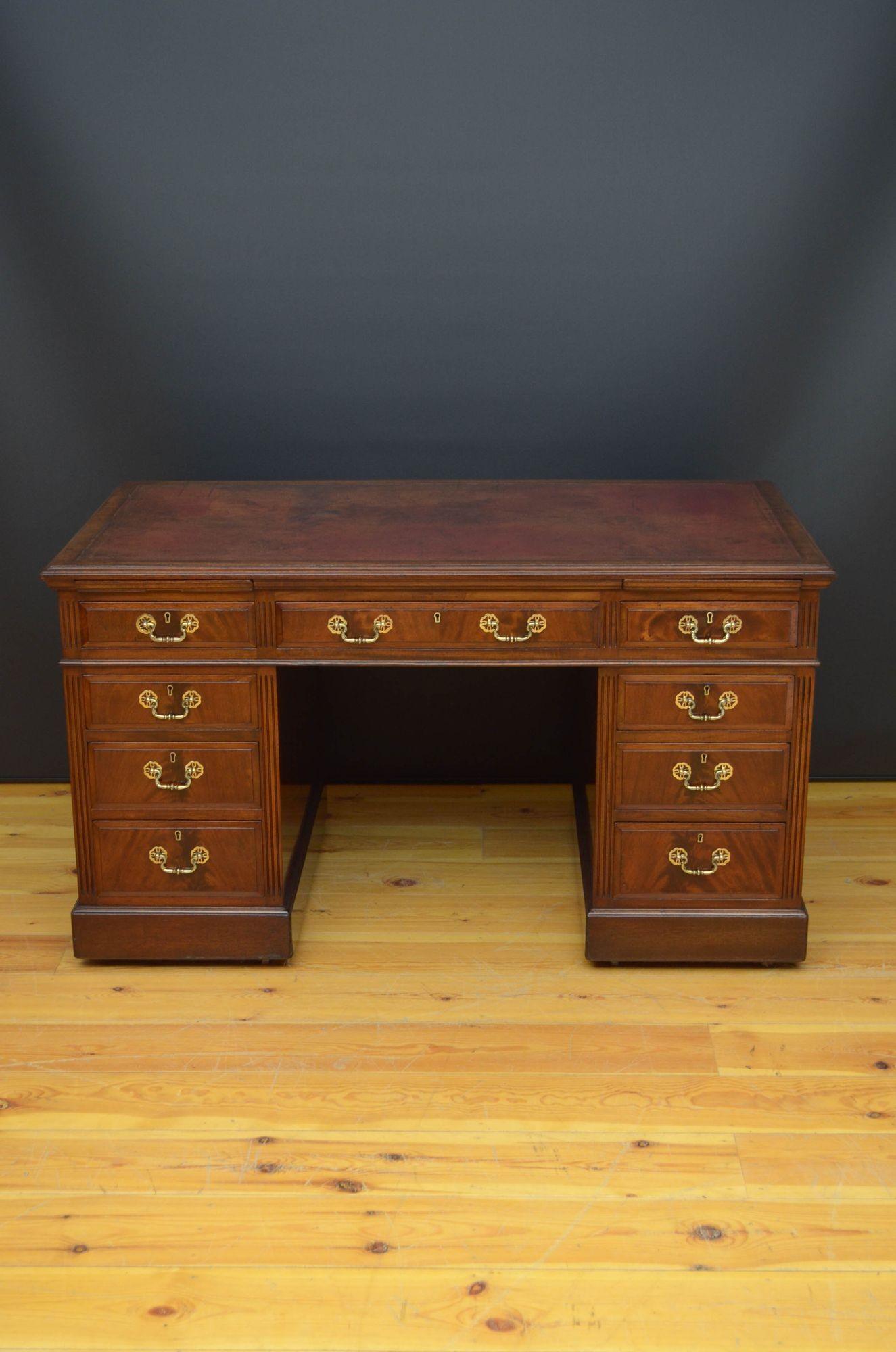 R012 Victorian mahogany pedestal desk, having original tooled leather to the top above to sliders and nine flamed mahogany and fielded frieze drawers all mahogany lined, all fitted with original brass handles, standing on moulded plinth base and