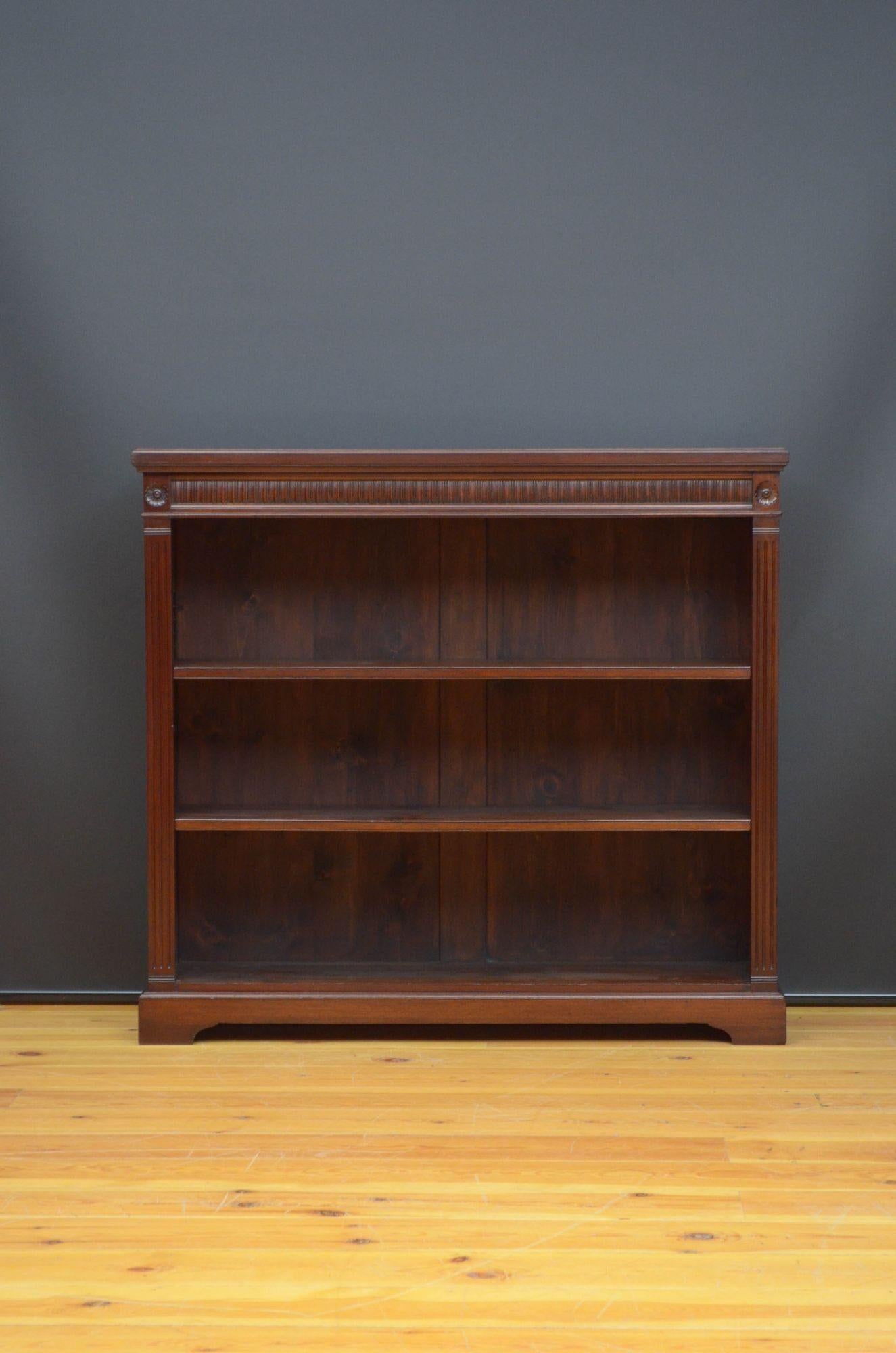 J012 Late Victorian mahogany bookcase, having figured top above concave reseeded frieze and two height adjustable shelves, all flanked by reeded pilasters and standing on shaped plinth base. This antique bookcase is in home ready condition.