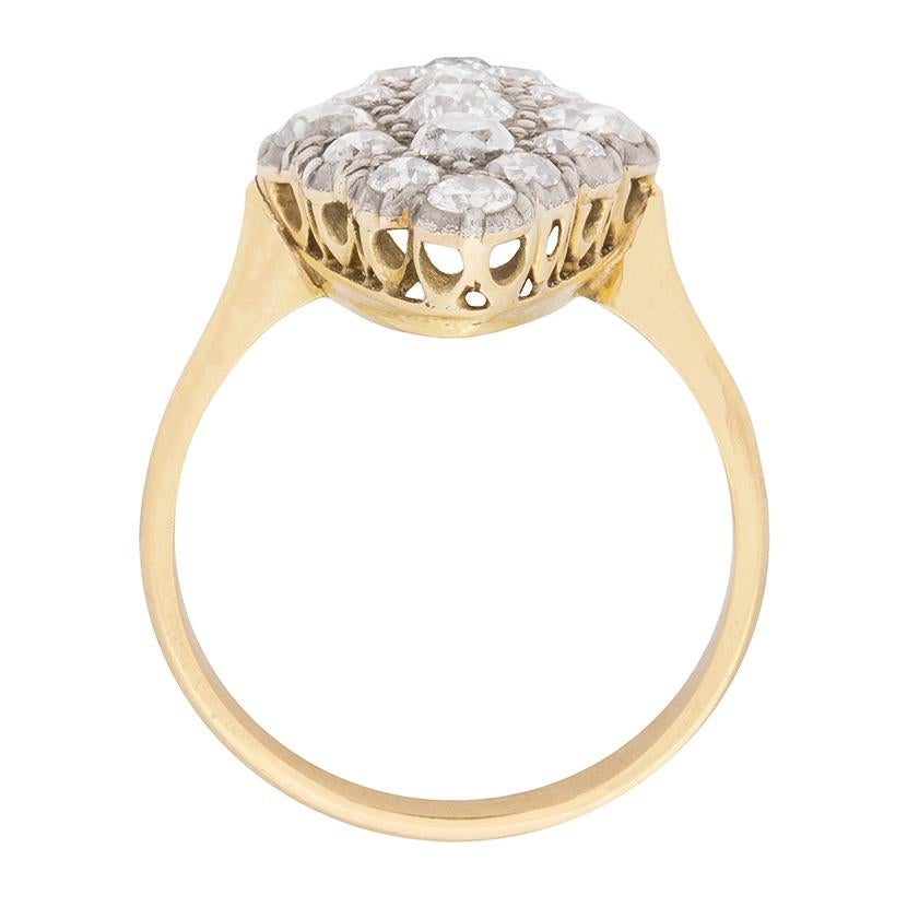 Originating in the early 1900s, this late Victorian era ring is grain set within a platinum marquise-shaped bezel with 1.90 carats of old cut diamonds. This handmade antique bezel is mounted atop a pierced gallery and shank in 18 carat yellow