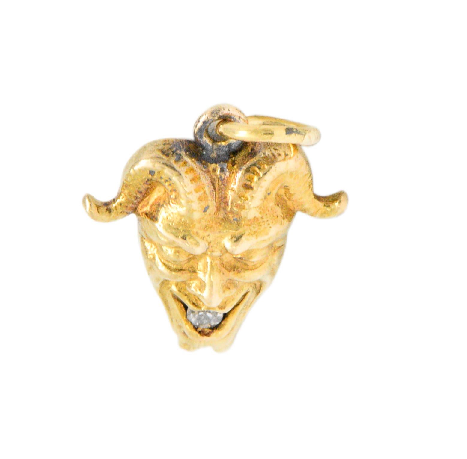 Featuring a very detailed solid gold devil charm with scrolled horns

1 Old mine cut diamond accent in the mouth

Measures 14 mm x 13 mm x 4 mm

Tested as 14k gold and marked

Total Weight: 1.4 Grams

Circa 1900 Late Victorian period

Ornate.