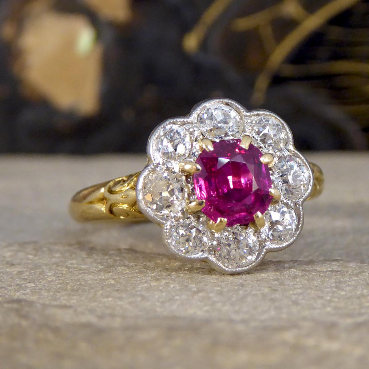 This gorgeous Late Victorian no heat Ruby and Diamond Cluster Ring is a remarkable piece of history, beautifully crafted in 18ct yellow gold. At its heart lies a stunning and rare, no heat Burma Ruby, its natural beauty preserved, radiating a deep,