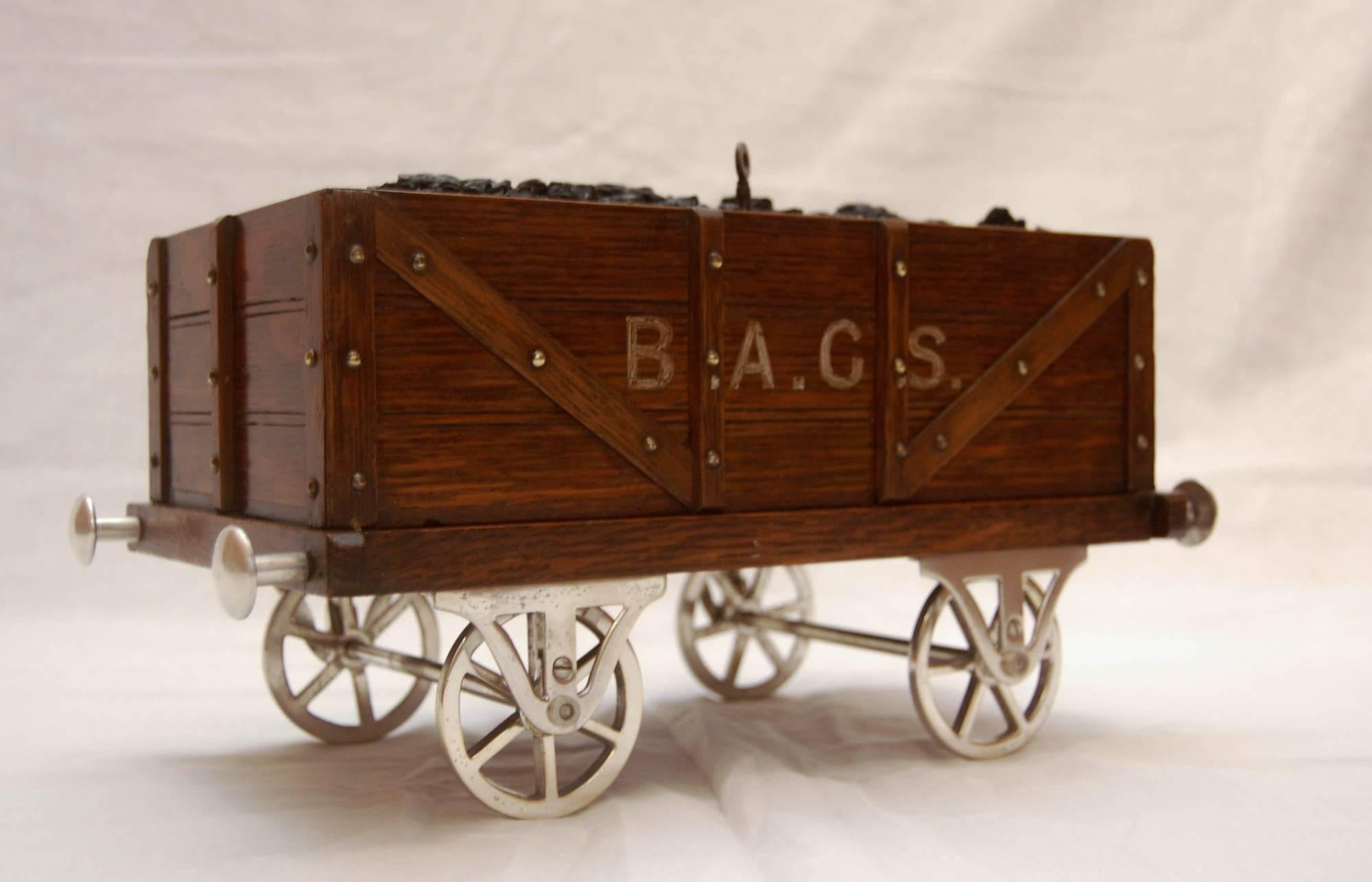 A late Victorian railway coal wagon tobacco box.

This large tobacco box was originally retailed and advertised as “The Railway Coal Waggon Cigar & Cigarette Cabinet. The Latest Novelty, Made in London” and has a registered design number 230537
