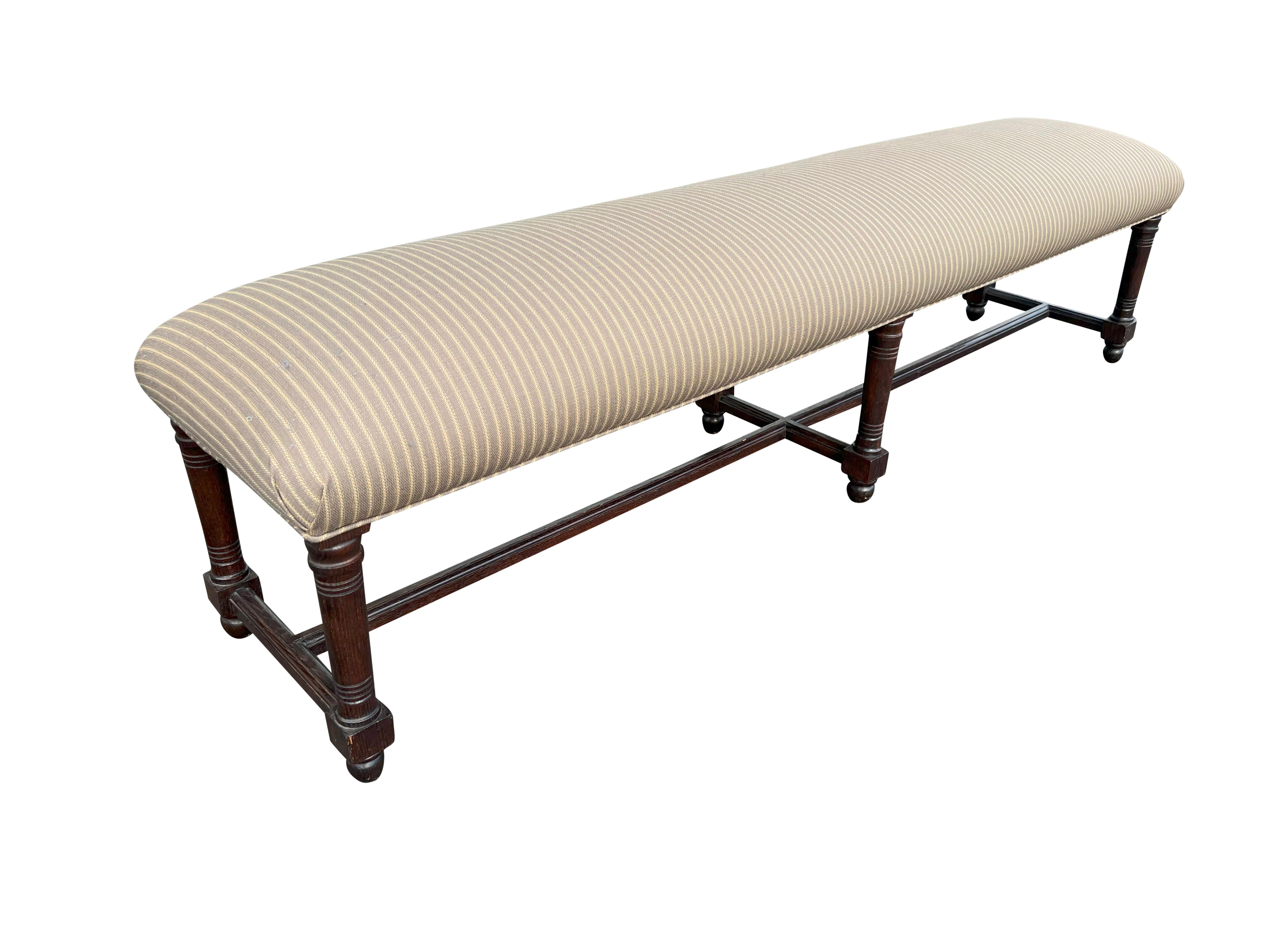 With an upholstered seat raised on turned legs joined by stretchers. Another is available.