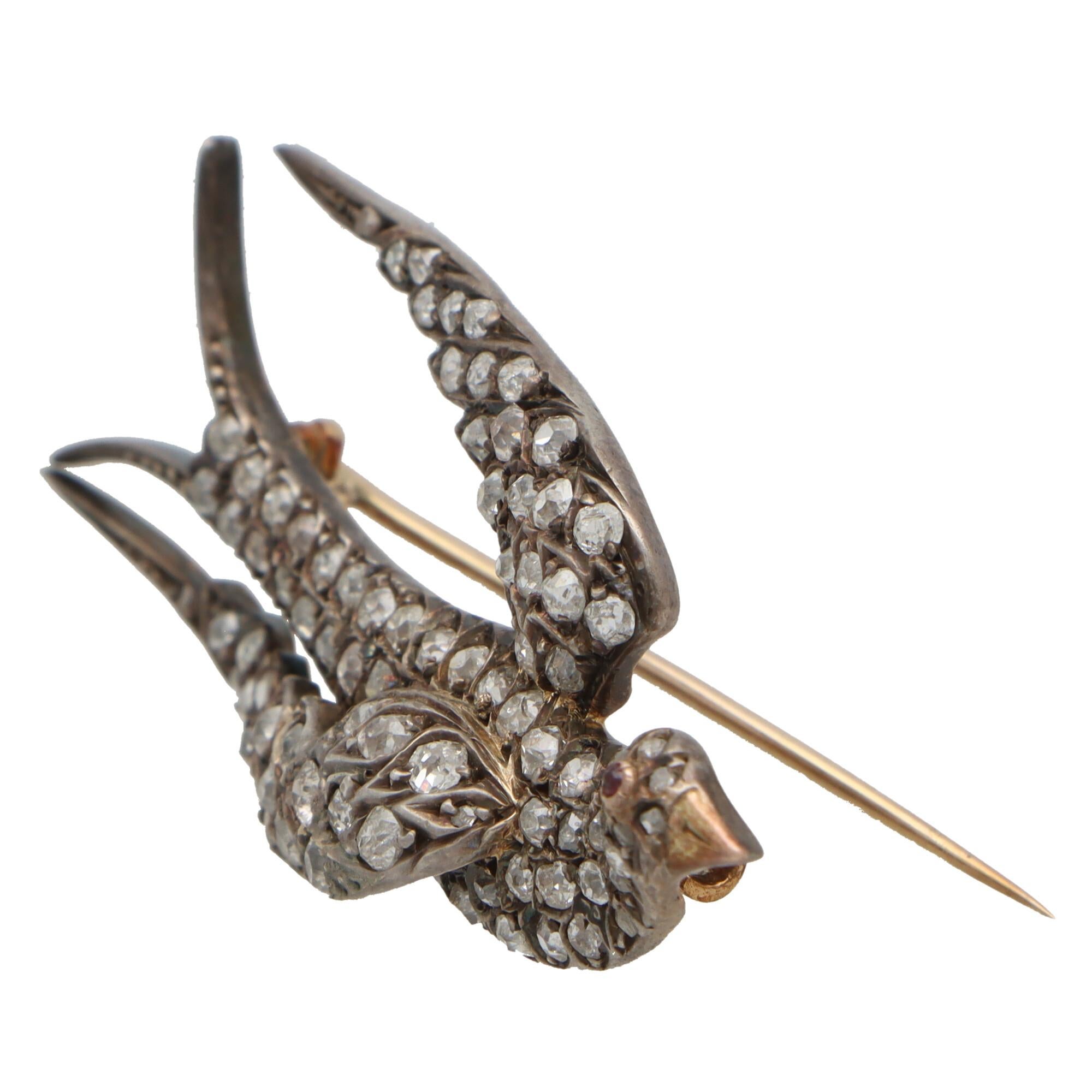  A beautiful Late Victorian diamond bird brooch set in silver on gold. 

The brooch depicts a sweet flying bird set throughout with a mixture of rose cut and old cut diamonds. The piece has been cleverly crafted and designed so that each diamond is