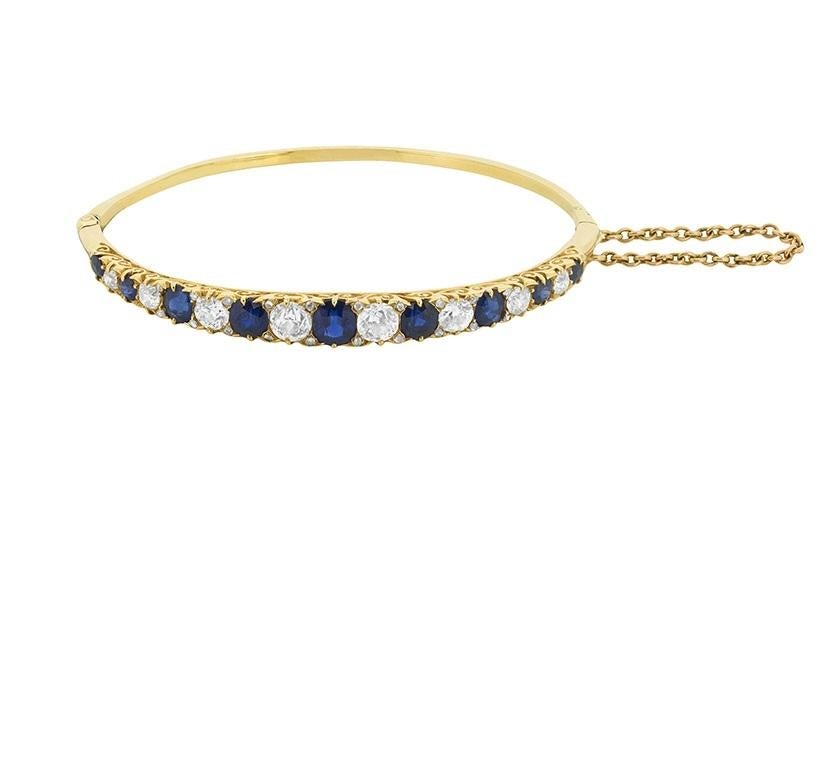 Old cut sapphires and diamonds alternate in perfect harmony across the top of this colourful late Victorian era bangle bracelet.

From the 0.80 carat sapphire at the bracelet's centre, the stones graduate in size from 0.65 carats down to 0.20