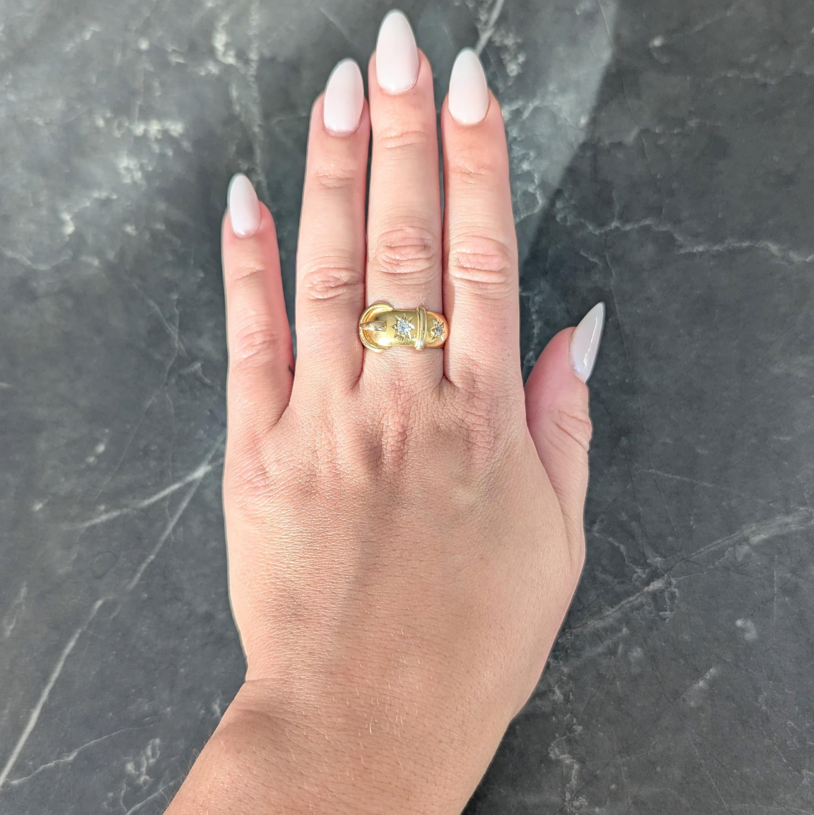 Designed as a wide band ring with dimensional buckle motif
Comprised of raised fastener and grooved tongue detailing
Featuring two old mine cut diamonds bead set to front
Weighing approximately 0.20 carat total
Eye clean and bright - set inside