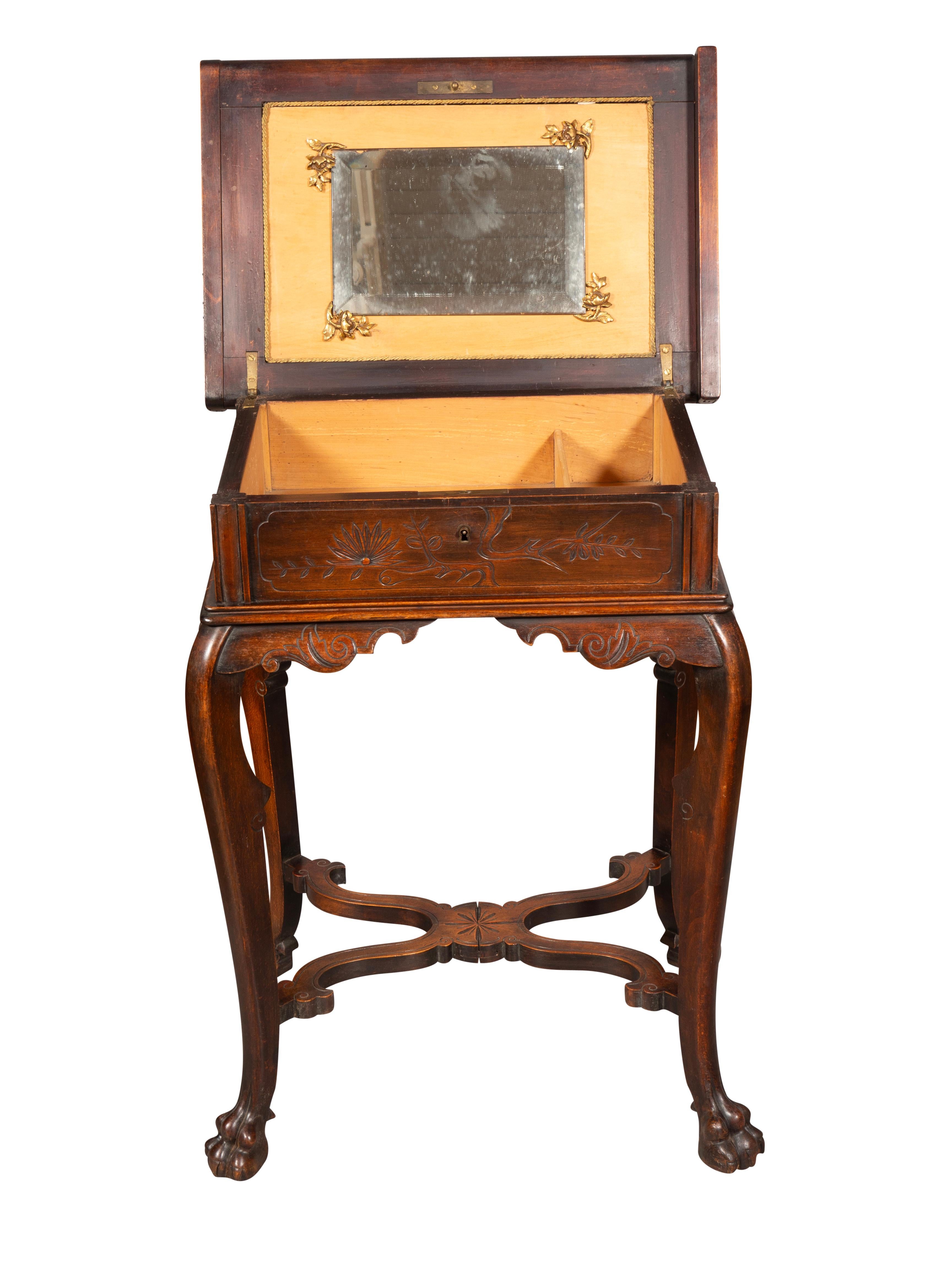 Unusual Asian inspired table with lift top exposing a well and mirror. Case with Asian inspired decoration with cabriole legs with X stretcher and paw feet.