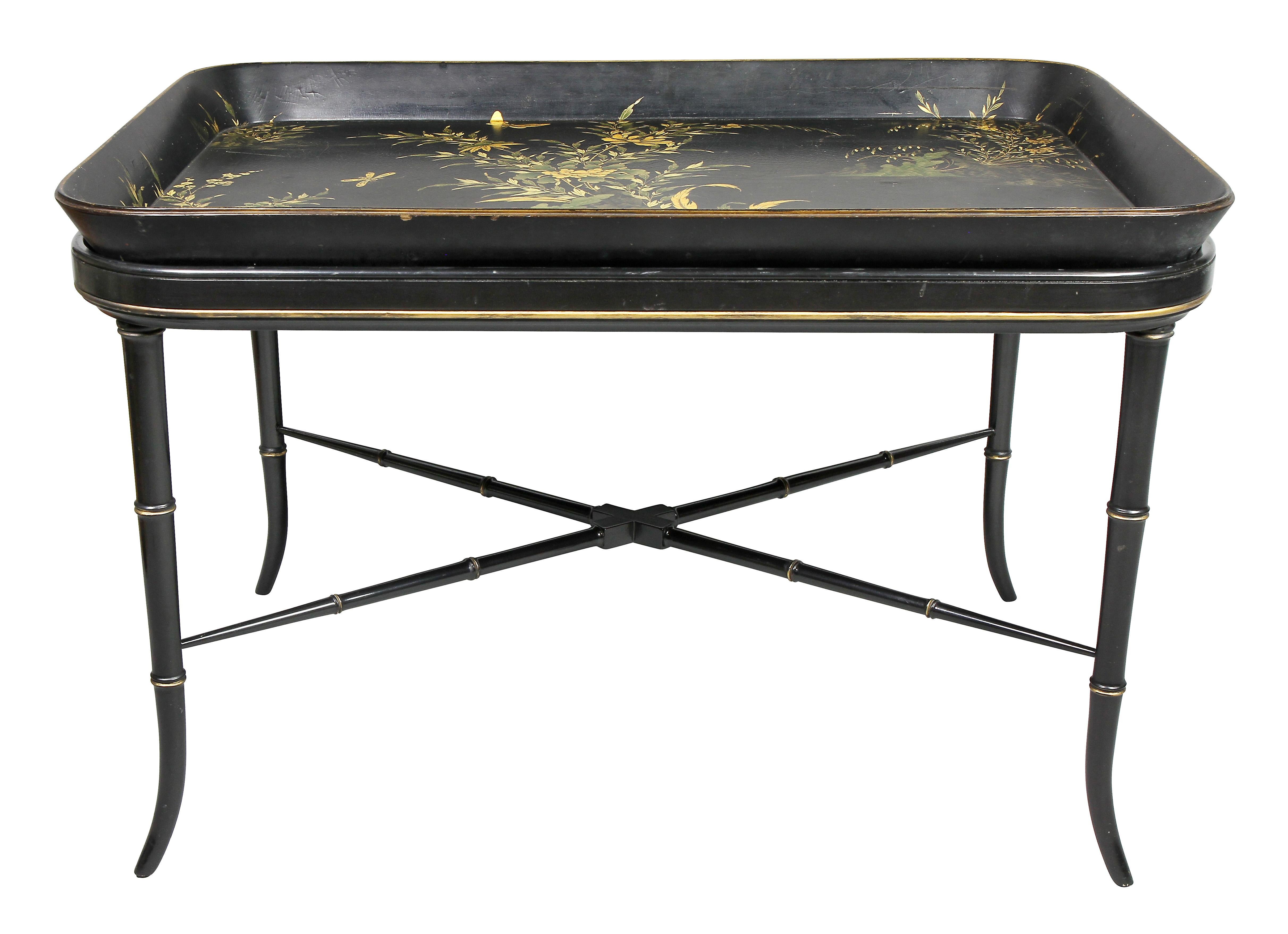 Rectangular shape with black ground decorated with flowers, leaves and butterflies, later bamboo turned base.
