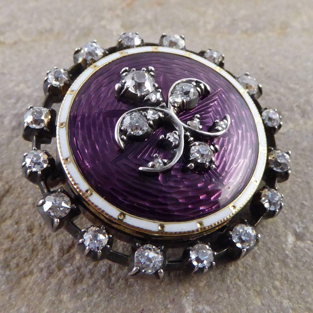 This beautiful piece was crafted in the Late Victorian era. It features twenty seven diamonds set into gold and purple guilloche enamel.
Opening as a locket, you have a small space to carry a keepsake! Currently filled with a locket of hair as part