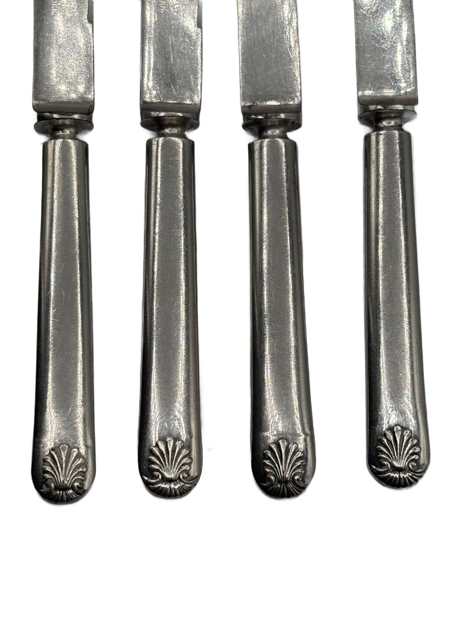 Set of 4 late Victorian silverplate Rogers Meriden, Conn, Shell Design dessert luncheon knives. Each knife comes with a shell design along the bottom of the handle.

Stamped: 