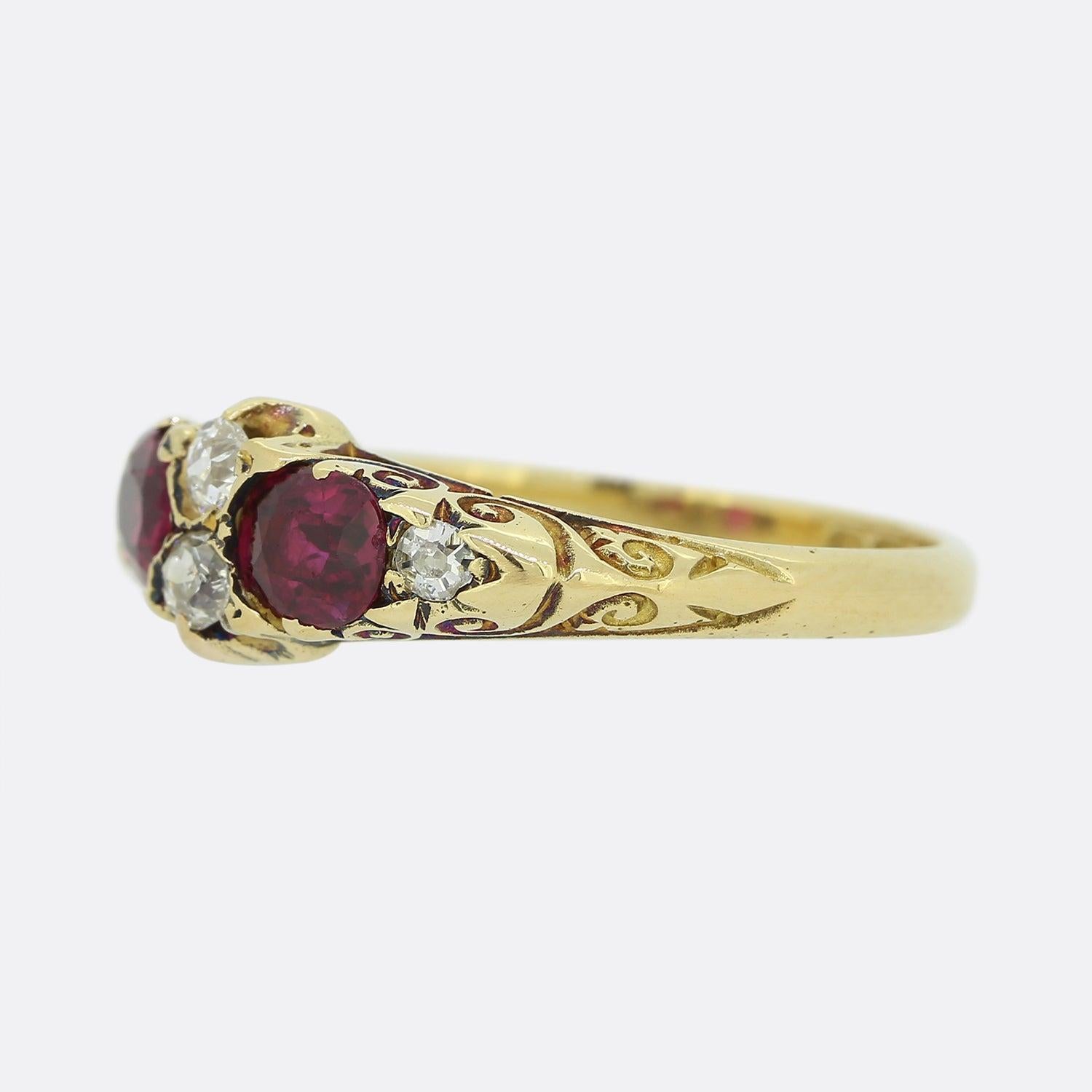 This is an antique ruby and diamond ring dating back to the late Victorian era. The ring features two oval cut rubies with two old cut diamonds in the centre with a further one diamond on each shoulder. The ring has been crafted in 18ct yellow gold