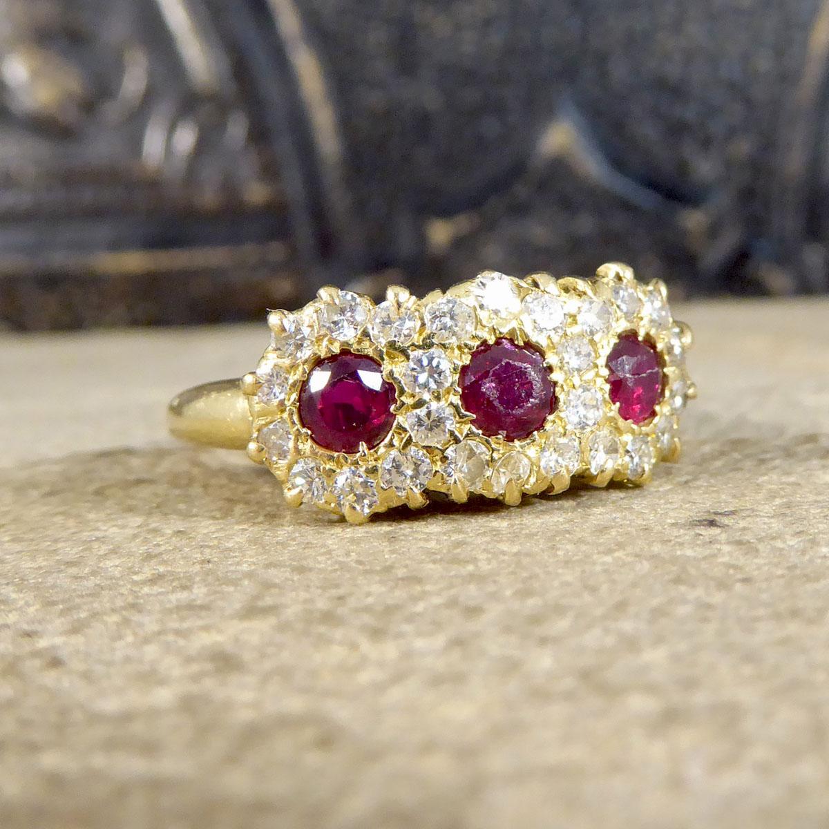 Such a beautiful antique ring that has been hand crafted in the Late Victorian era. This ring is created as a triple cluster featuring three round cut Rubies surrounded by cluster of Diamonds all in a claw setting. The wear on this ring and stones