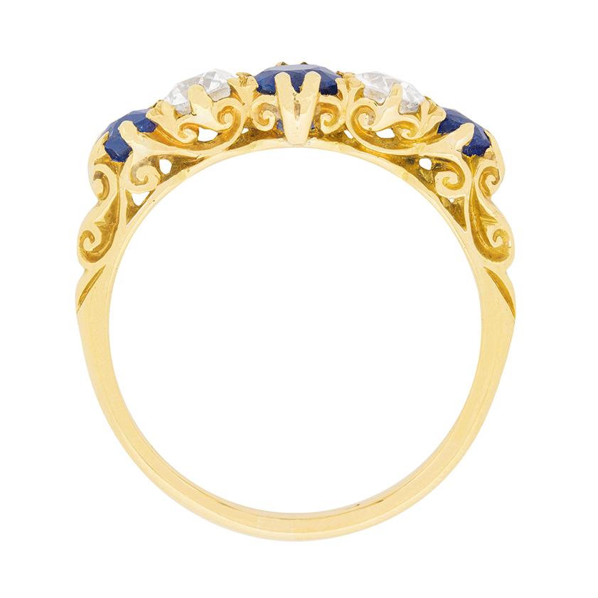 This late Victorian era five stone sapphire and diamond ring is a quintessential example of one of the era’s most loved styles.

This original period ring features three gorgeous, old cut natural sapphires alternating with two 0.25ct old cut