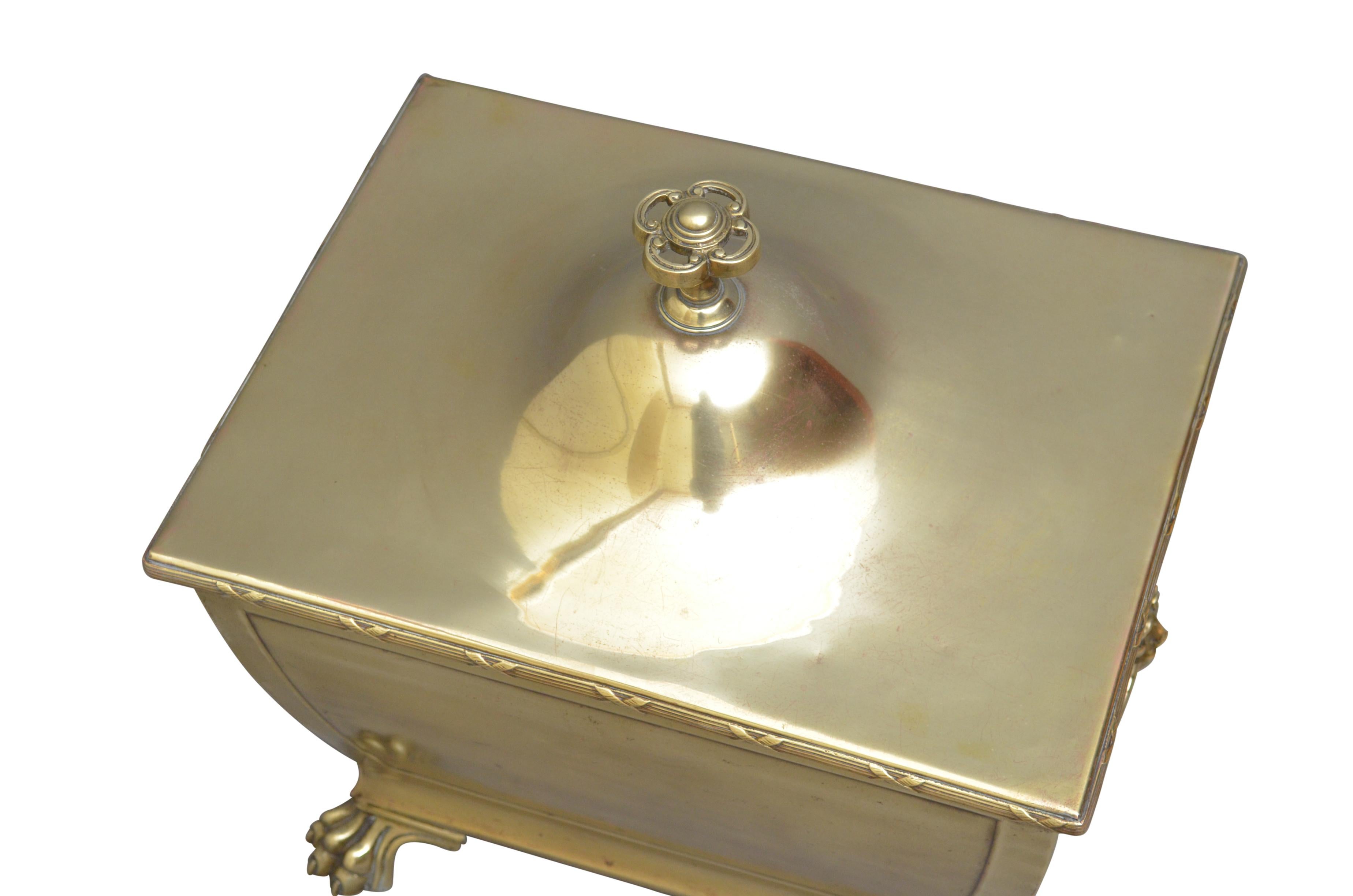 Unusual late 19th century brass coal or log bin with lift up lid enclosing original liner, lion mask carrying handles and 4 paw feet. Cleaned, polished and ready to use at home. c1890
Measures: H 18.5