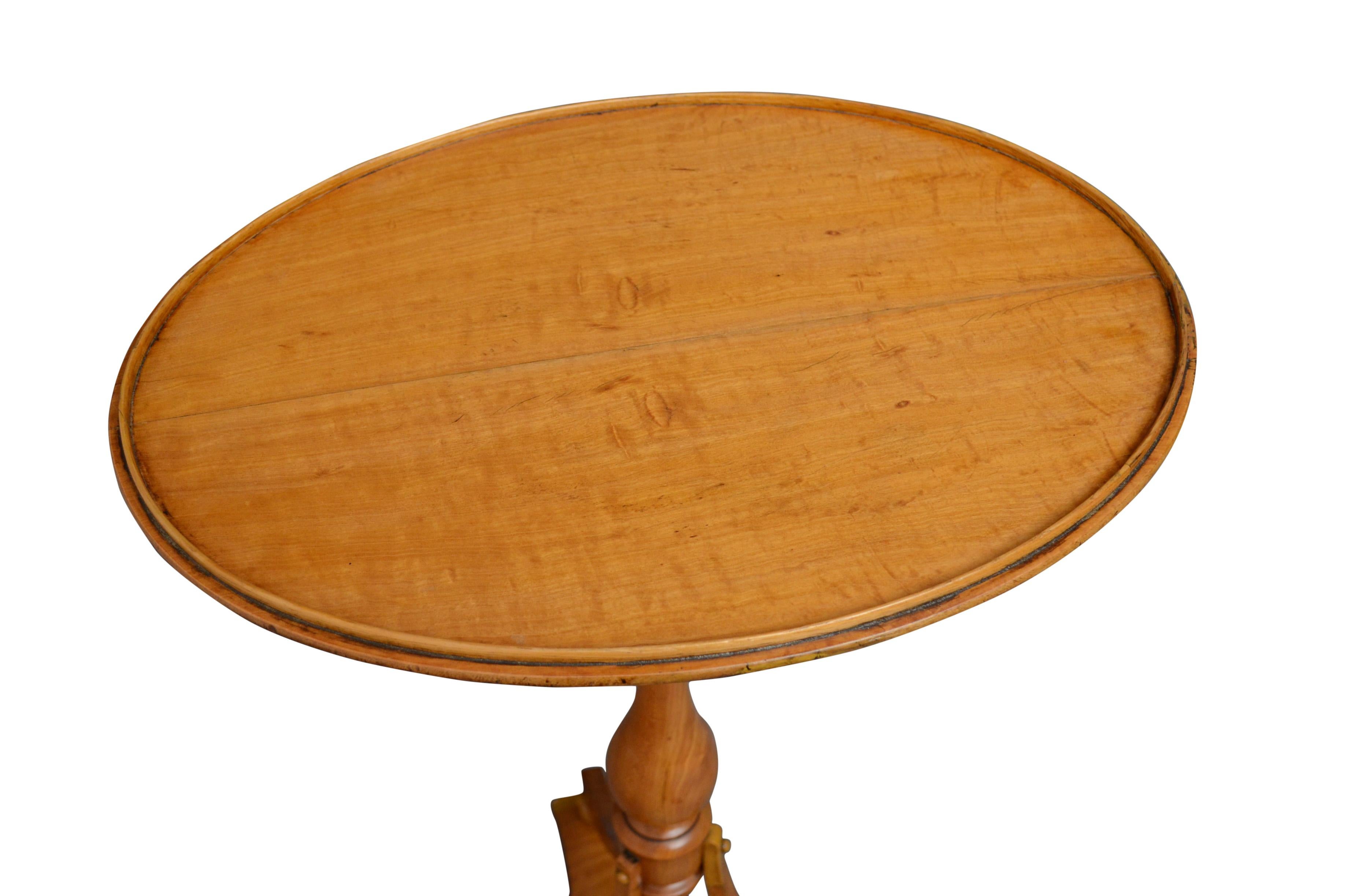 K0446 stylish late Victorian lamp table in satinwood, having oval top and turned column terminating in trefoil base and bun feet. This antique table retains its original finish with minor touching up and is in home ready condition. C1890
Measures: