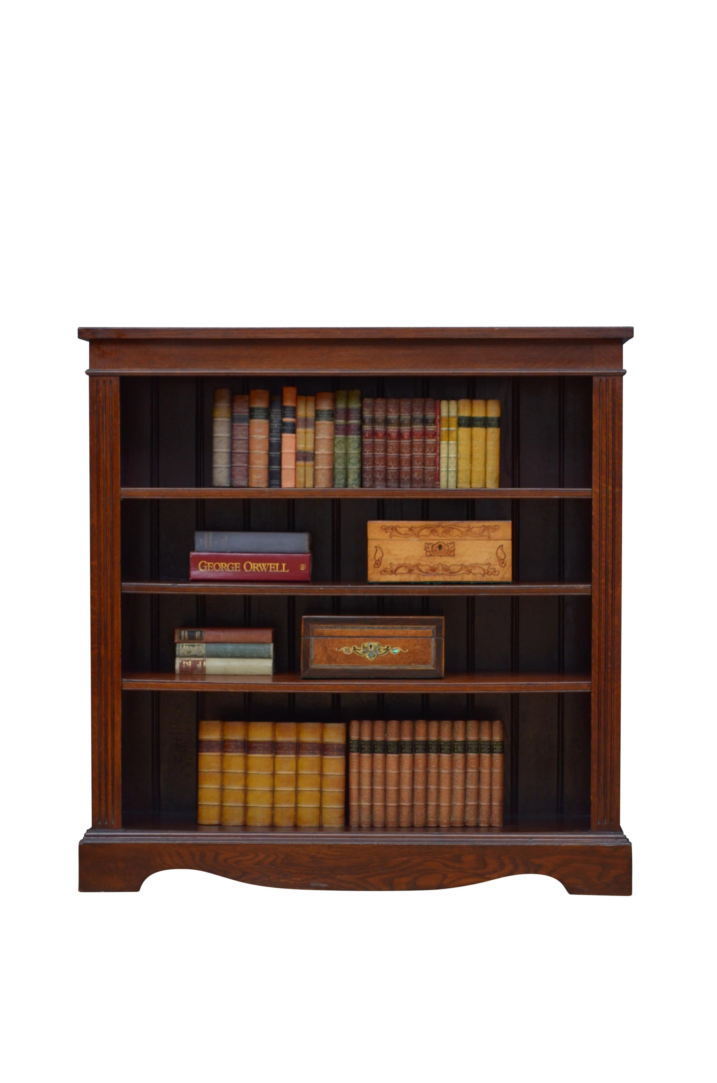K0616 Simple and elegant Victorian bookcase in solid oak, having oversailing top above a shallow frieze and three height adjustable shelves, all flanked by reeded pilasters, standing on shaped and moulded plinth base. This antique bookcase retains