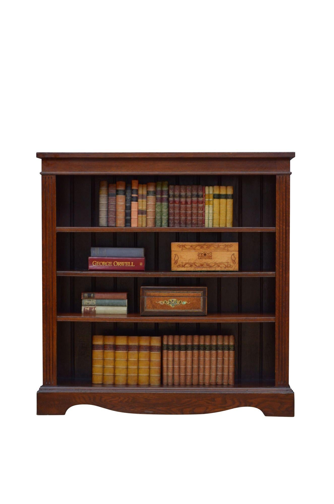 K0616 Simple and elegant Victorian bookcase in solid oak, having oversailing top above a shallow frieze and three height adjustable shelves, all flanked by reeded pilasters, standing on shaped and moulded plinth base. This antique bookcase retains