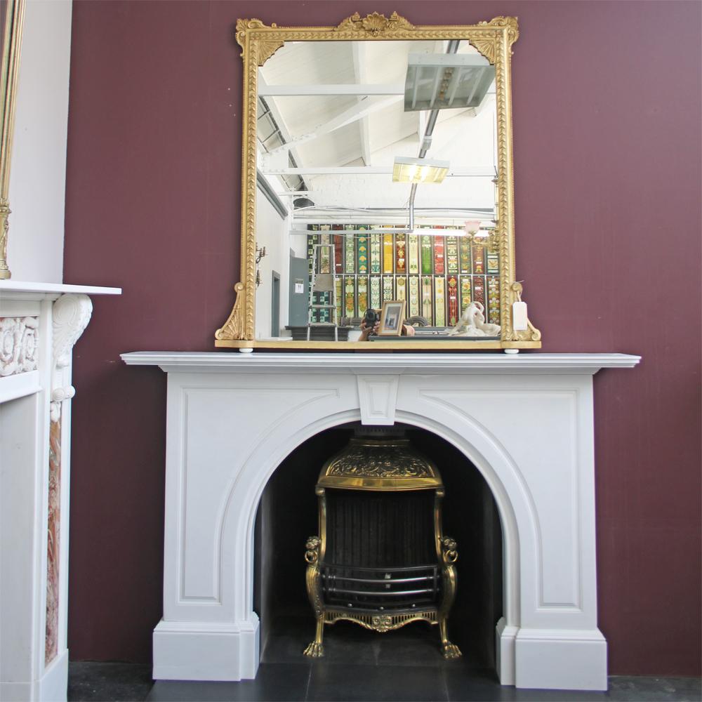 A Late Victorian statuary marble fireplace with an arched aperture, the spandrels are decorated with fielded panels as is the keystone. Removed from a fine property in Malvern, Worcestershire, circa 1880.

Pictured here in our showroom set up with