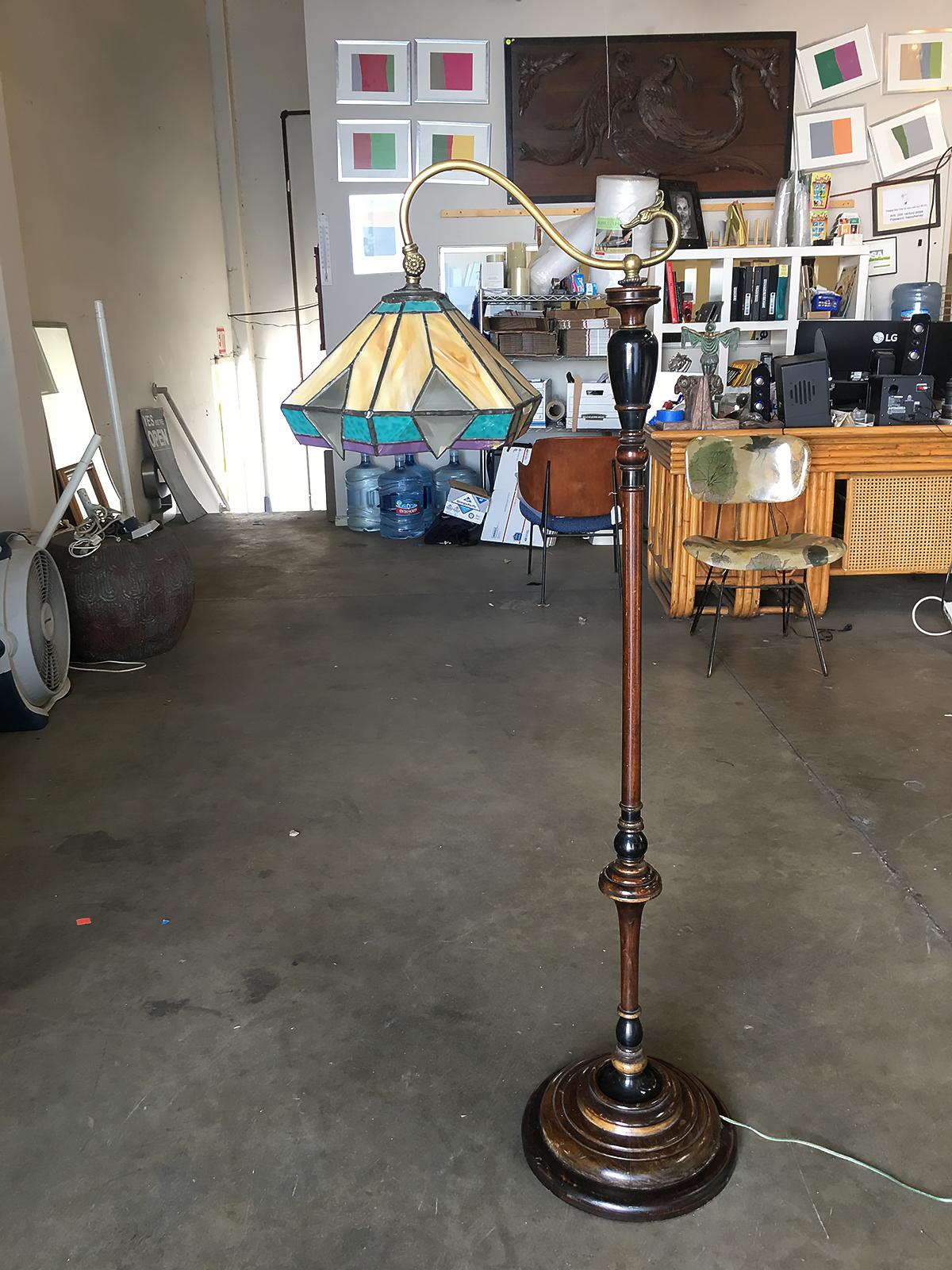 Late Victorian style floor lamp with sculpted dark wood body with onyx glass accents and a Tiffany Inspired stain glass shade.
