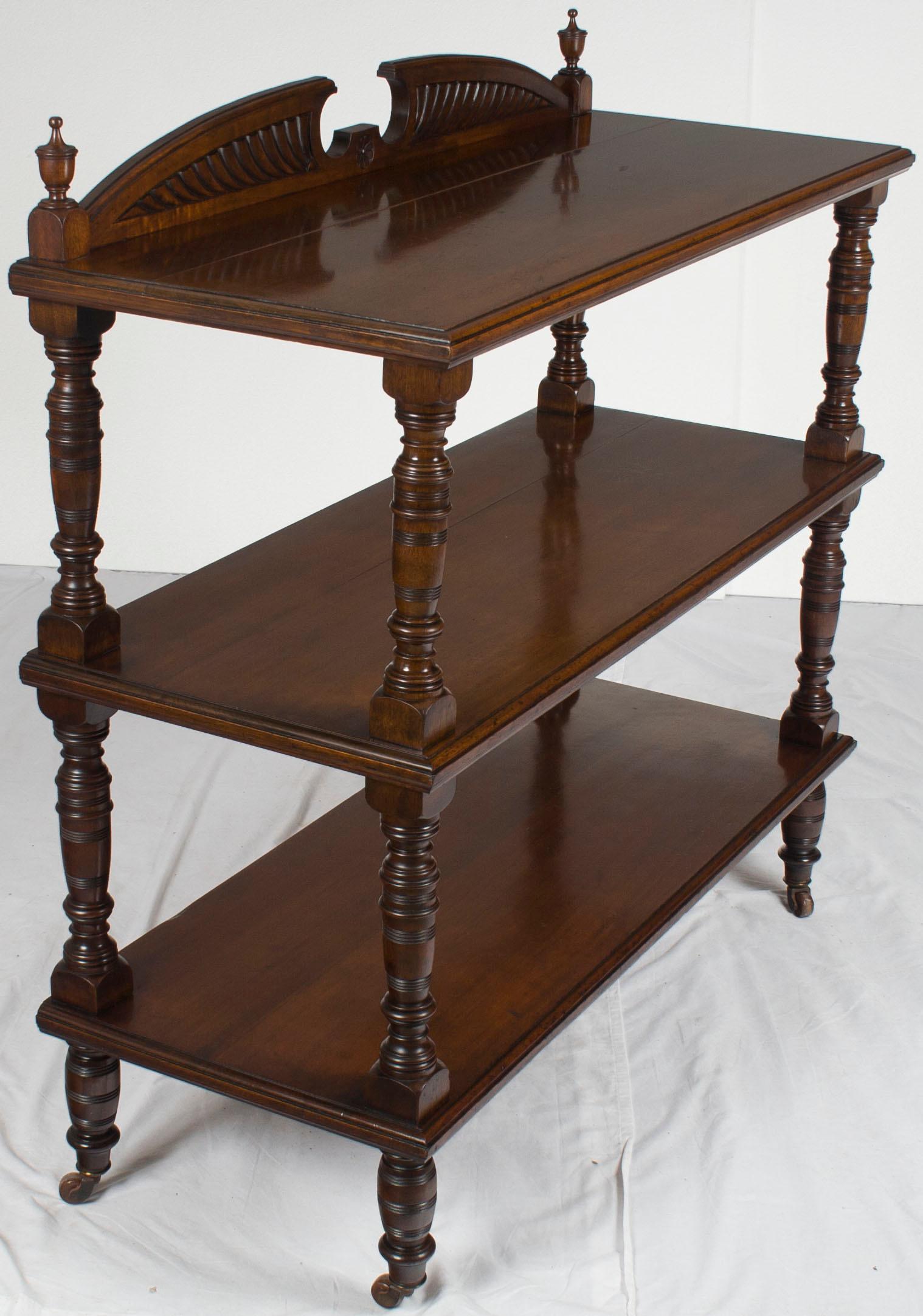 This English mahogany three-tier server was made during the late Victorian period, circa 1900. Also known as a dumb waiter or étagère this piece would traditionally have gone in a dining room and meals would have been served from it. Today we use