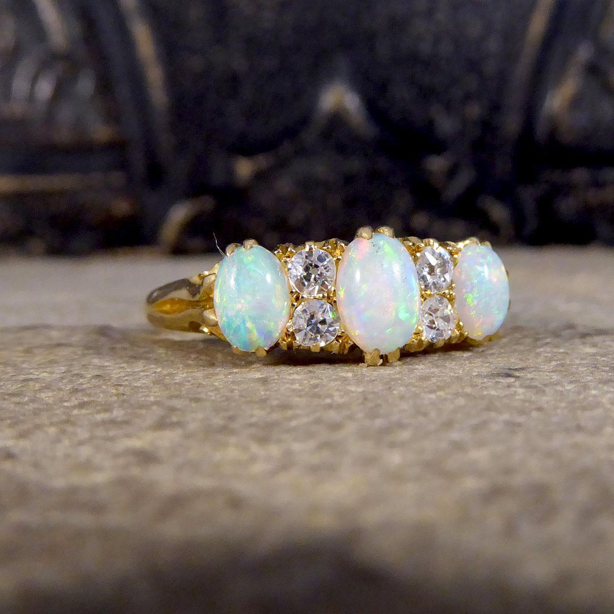 The most vibrant Opals feature in this gorgeous antique ring hand crafted in the Late Victorian era. There are three very colourful Opals in this ring, with the centre Opal being slightly larger and two Diamond spacers in-between each stone. As well