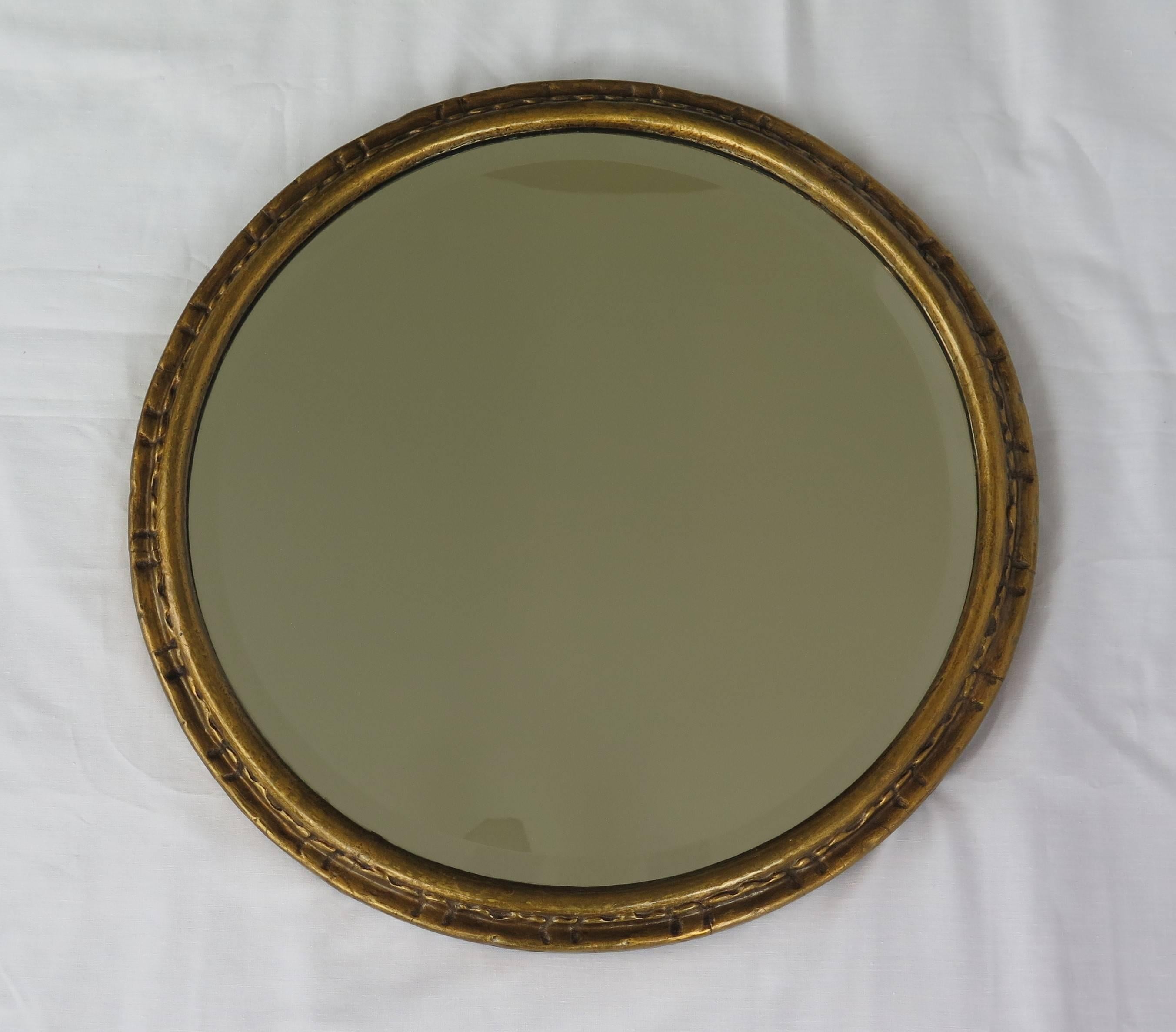 This is a good quality circular bevel glass wall mirror from the English late Victorian period, circa 1885.

The circular or round frame has a gold gilt-wood finish with a decorative moulded design to the outer frame as per the images. The mirror