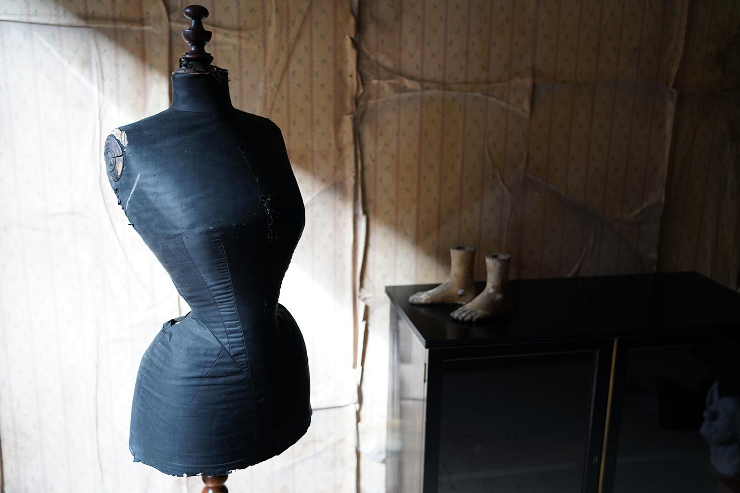 The good quality shop display mannequin having a well-turned adjustable bobbin stand to a wasp waisted form of Parisian origin, having hand written numbering ‘35670’ and ‘Paris’ to its underside, with the original black linen covering, to a turned