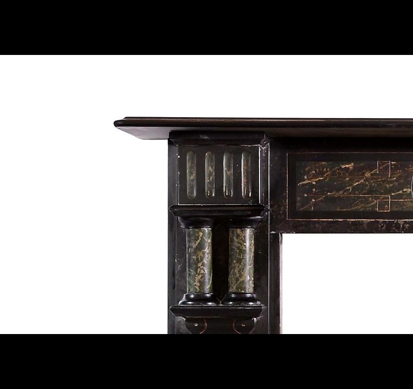 Late Victorian Welsh slate mantel with painted marble effect panels and lantern corbels. Opening dimensions: 35.25