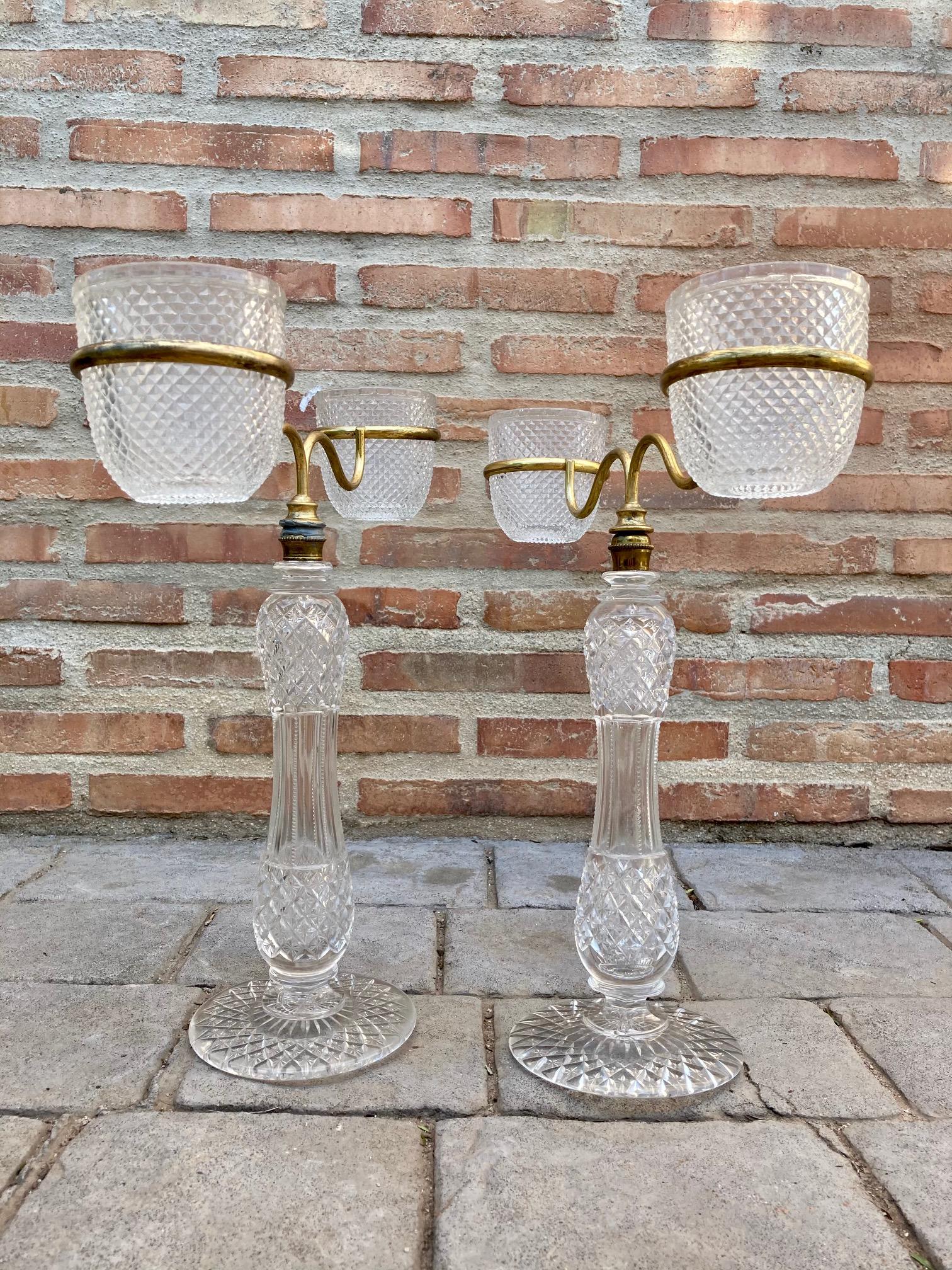 Late XIX pair of Victorian cut glass candle holders in brass from Cricklite Clarke trade. A rare late 19th century Cricklite Clarke Victorian candle holder comprising a cut glass base into which an arm is screwed with two lamp goblet rings and into