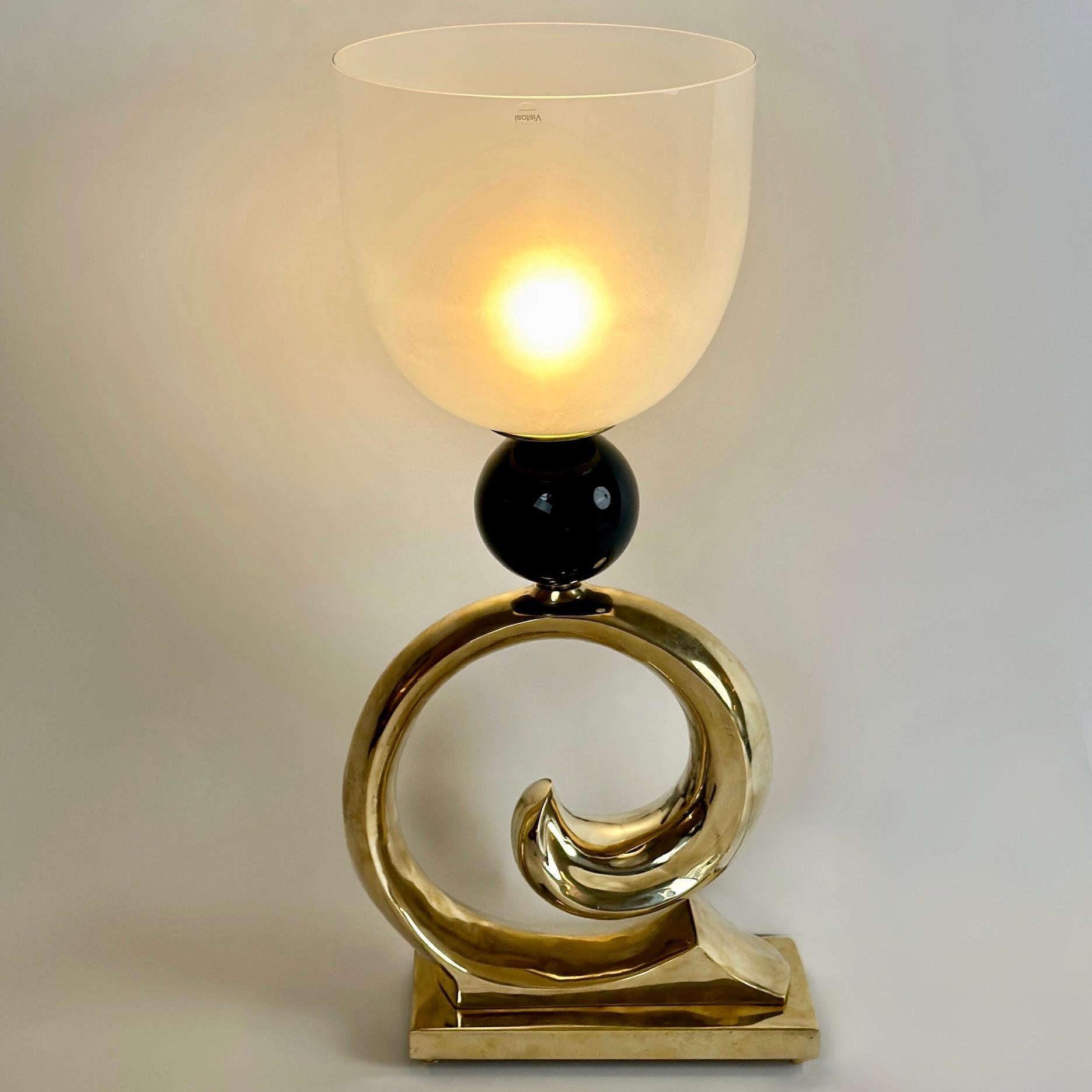 Stunning prototype that was never put into production by Vetrerie Vistosi. Brass body imitating a wave with a black ceramic boule and round white frosted Murano glass shade (30 diam. x 28 H cm.) to cover the E27 light bulb. The lamp comes with an
