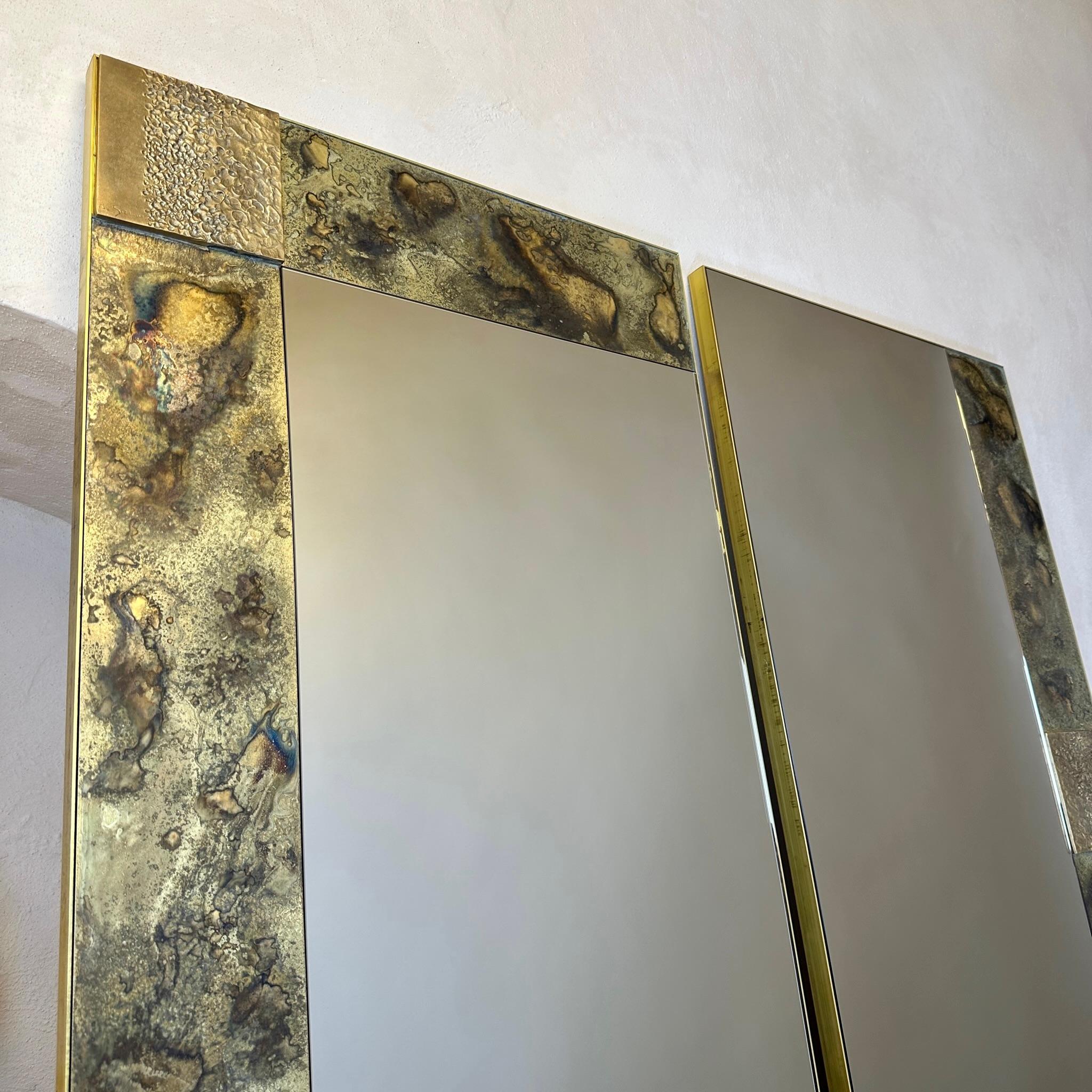 This pair of stunning sculptural bronze mirrors & etched brass w/ bronze abstract plaques and brass frame can be hanged on the wall either in an horizontal or a vertical manner. The two mirrors put together on the wall measure: 120 x 3 x 120 H cm.