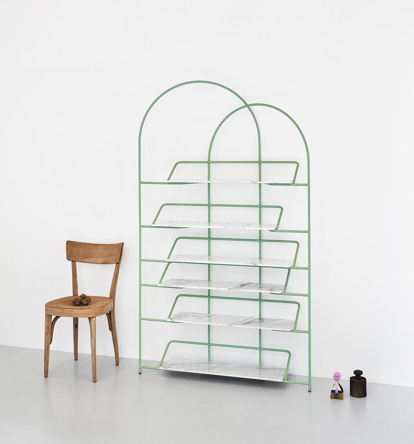 Two arches enclose and enhance stacks of books gently suspended from a light and resistant structure. 
Designed by Enrico Girotti for lapiegaWD LateB is a sculptural bookcase available in a painted or galvanized finish. The shelves are available in