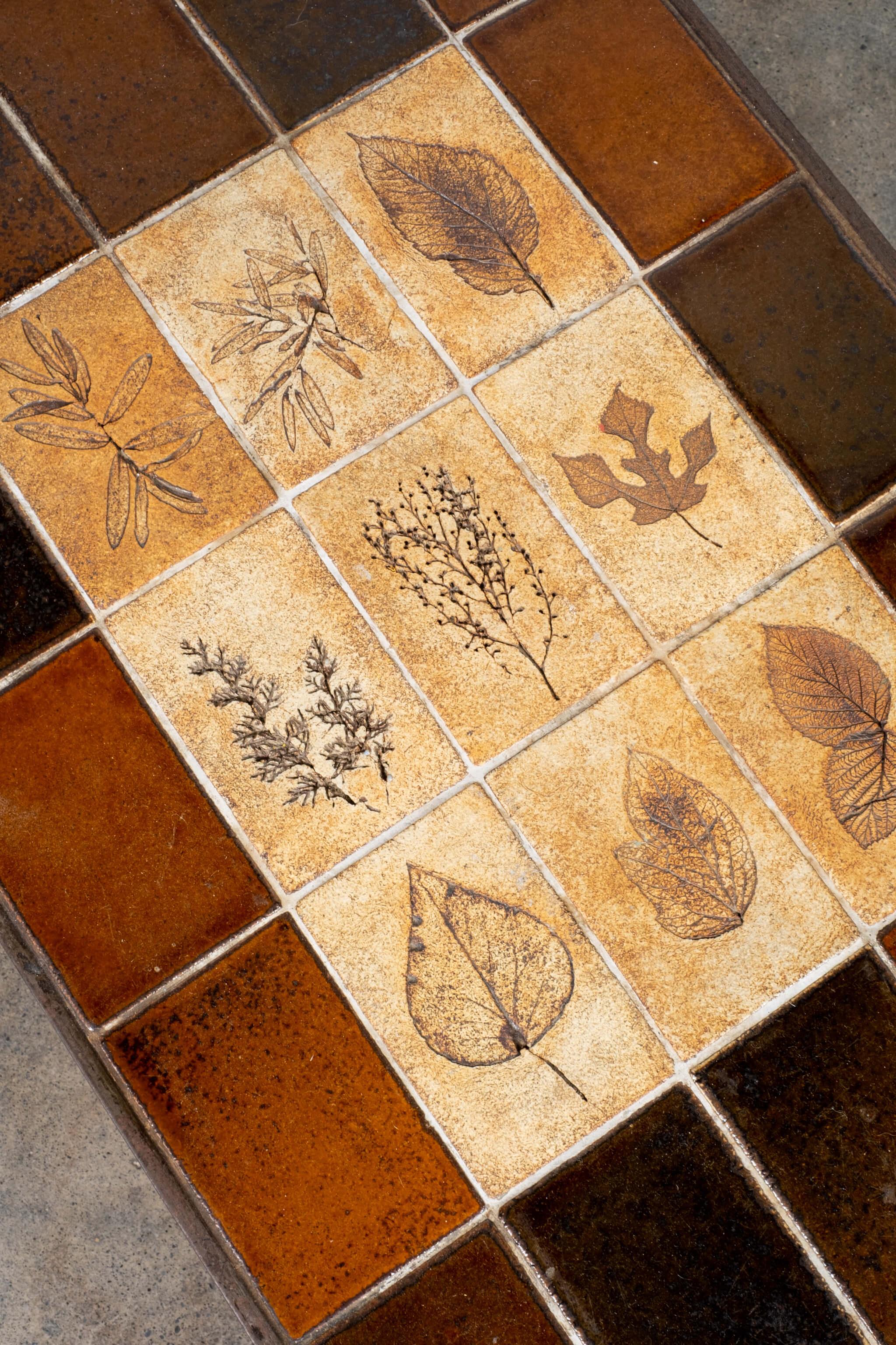 The handcrafted tiles, which were produced for about 15 years - from the mid 1960s to the late 1970s - were produced by a technique in which real leaves were pressed into the clay and disintegrated during firing, leaving a finely detailed imprint.