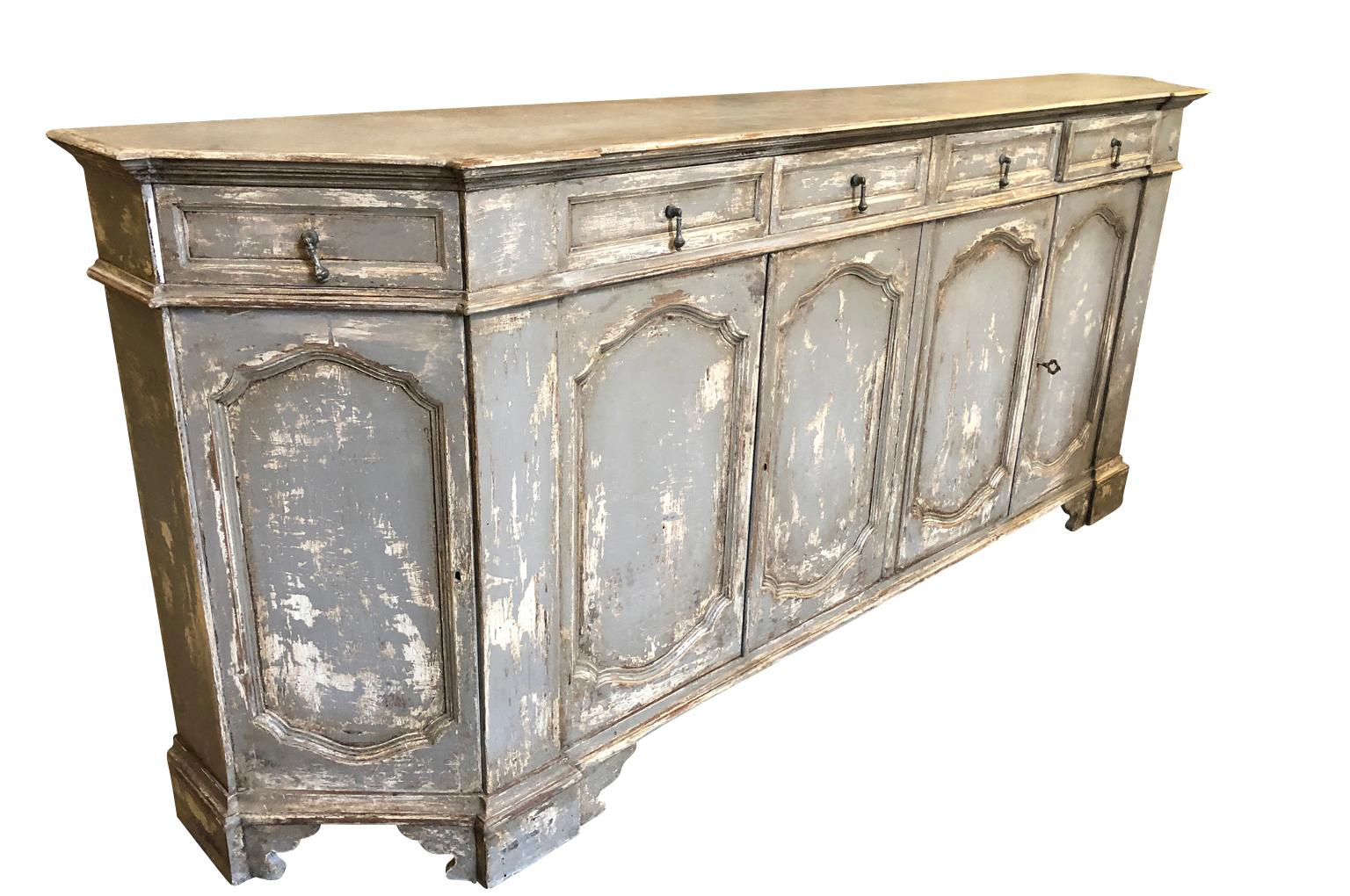 A very lovely later 19th century Italian credenza in painted wood. Soundly constructed with 6 doors and 6 drawers with a wonderfully sculpted form. A terrific storage piece.