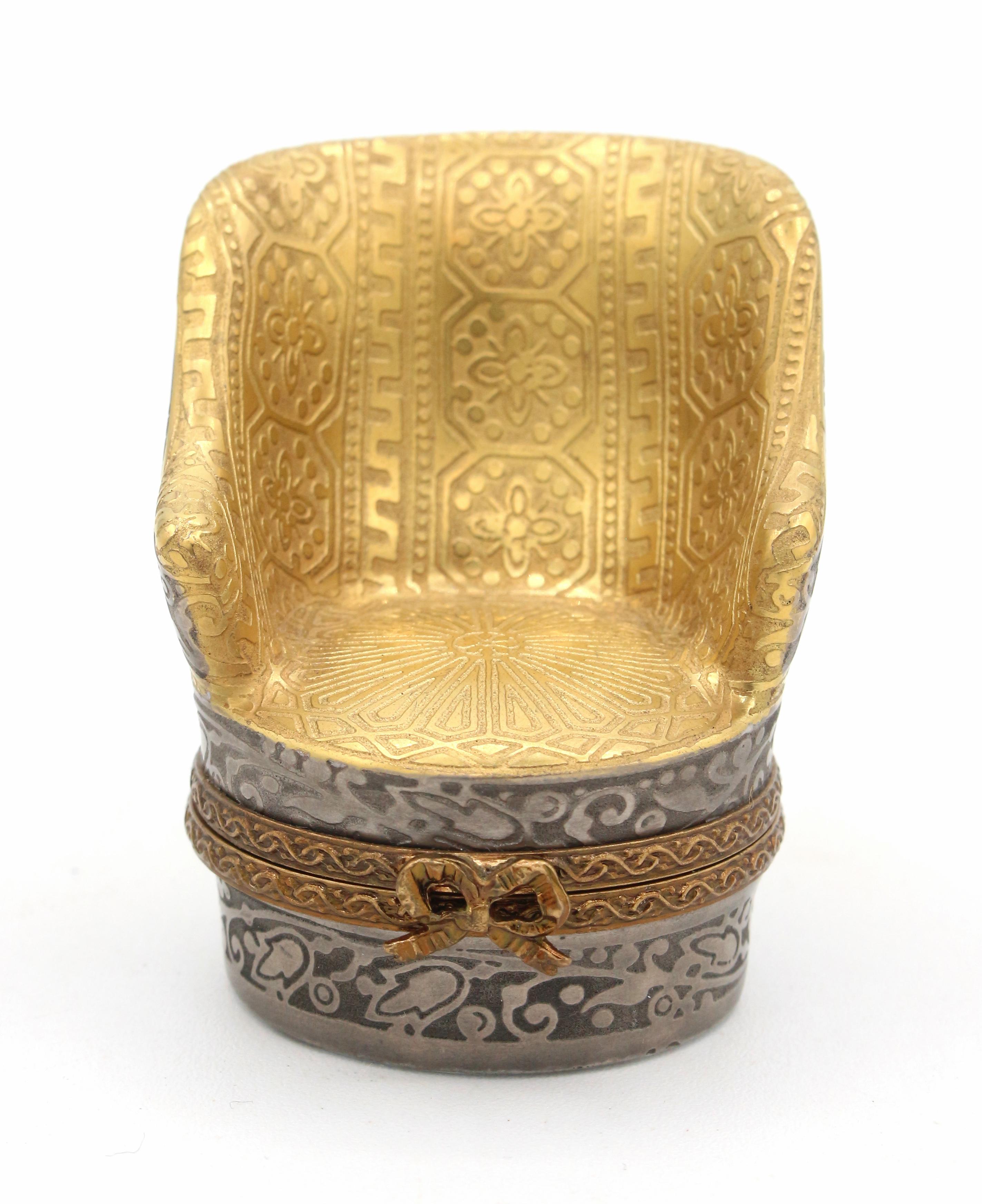 Limoges trinket or pill box in the form of a bergere chair, French later 20th century. 24k gold & silver encrused. Marked: Limoges France, Peint main, Incrustation or fin (painted by hand, fine gold inlay), & artist's mark. 
1 5/8