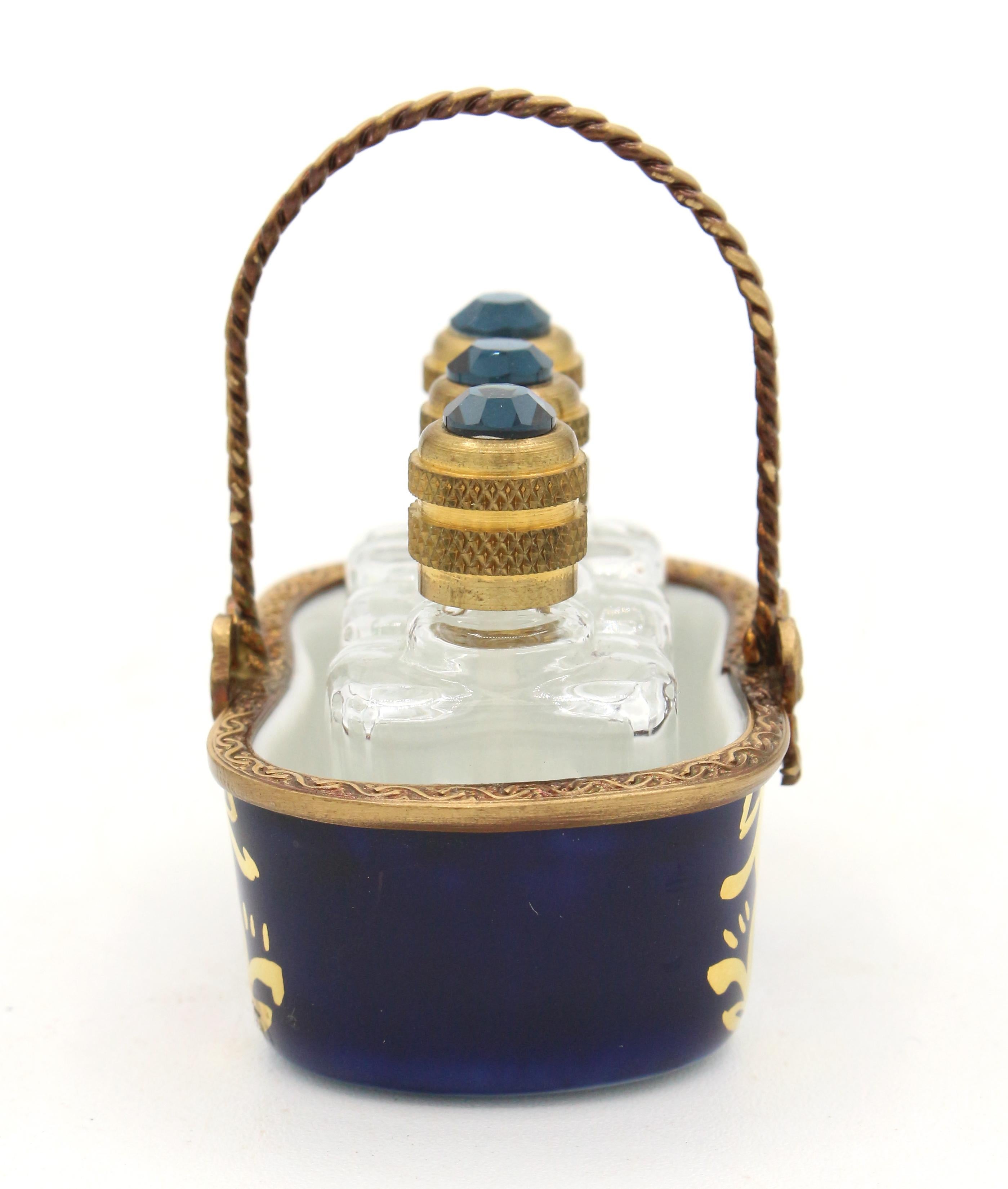 Limoges miniature basket holding three scent bottles, French later 20th century. Marked: Dubarry, Porcelaine de France , Ltd, Limoges, Made in France, Veritable, Bleu de Four.
2