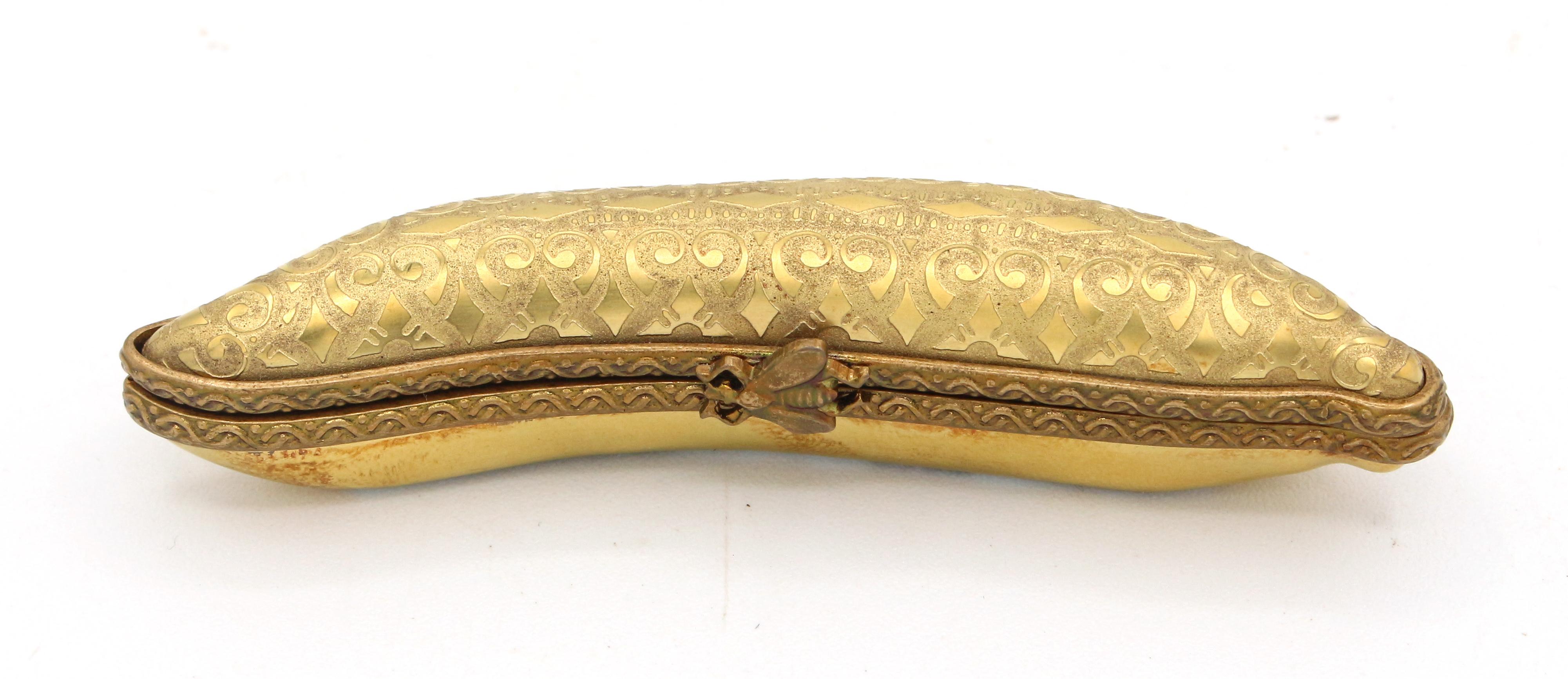 Limoges trinket box in the form five peas in a pod, French later 20th century. Bee clasp. Marked: Limoges France, Porcelaine D'Art Du Cruou, MCLS.
3 1/8