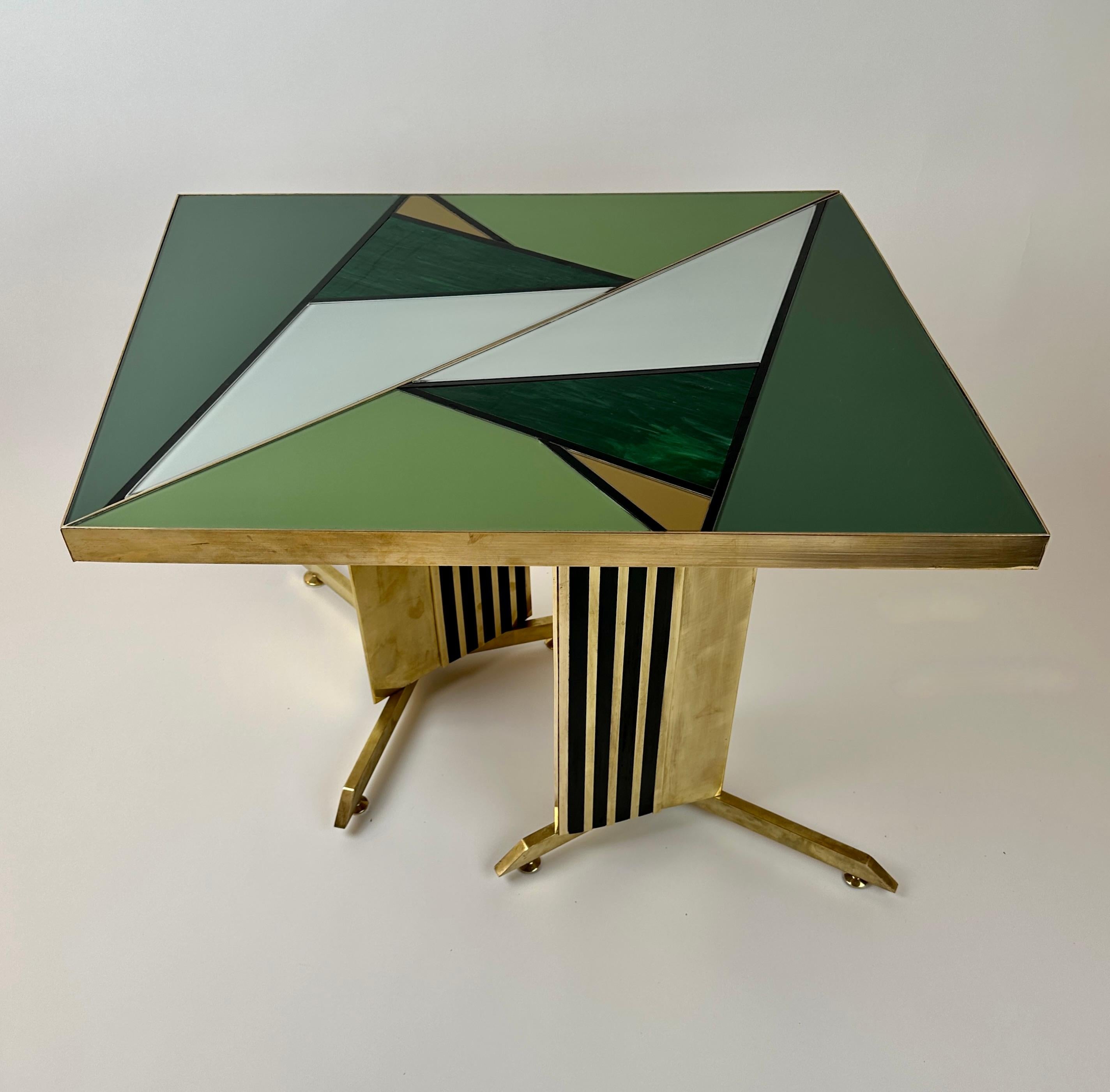Pair of stunning triangular side tables with a green, grey, gold & black opaline & Murano Art Glass Mosaic. The basement has a triangular body with black opaline glass stripes and adjustable brass feet. These living room tables can be displayed