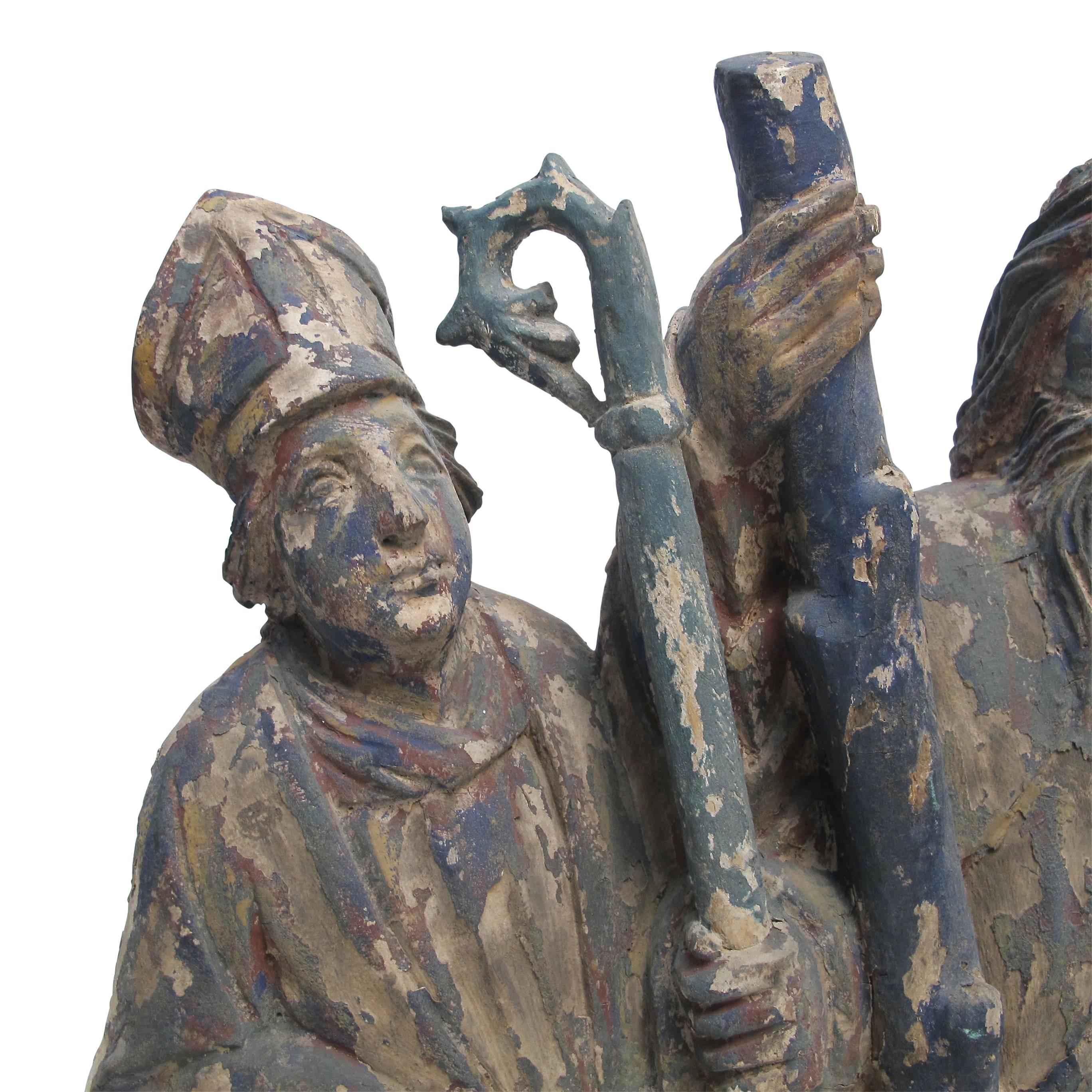Spanish Colonial carving of three saint figures, having remnants of original old paint, Mexico, early to mid-19th century.