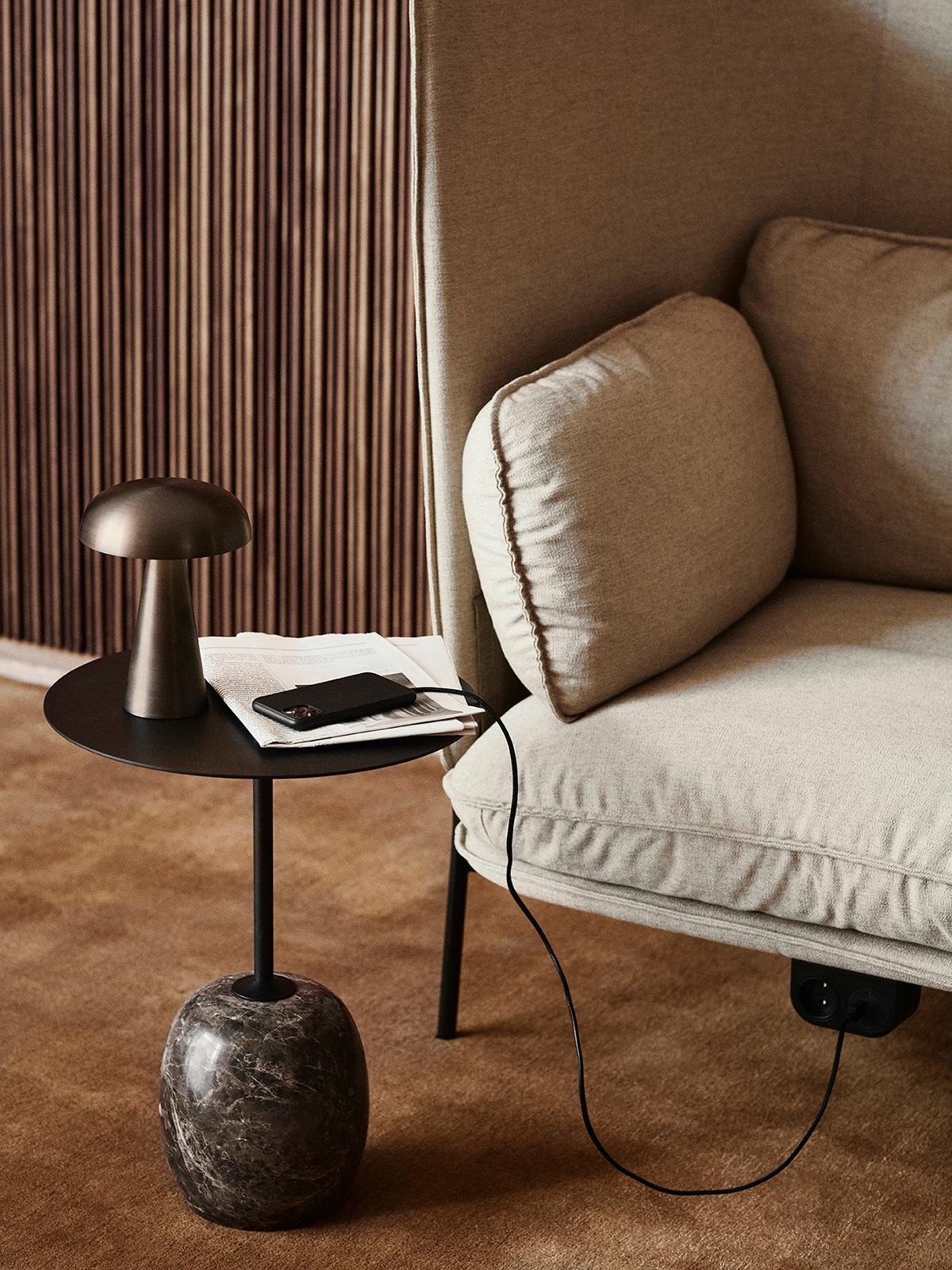 At first glance, Lato resembles a sculpture, with its slim, round table top balanced by an oval-shaped base. 
The marble is turned into shape on a lather and then honed to a semi Matt finish. 
The table is made from Warm Black Steel & Emparador