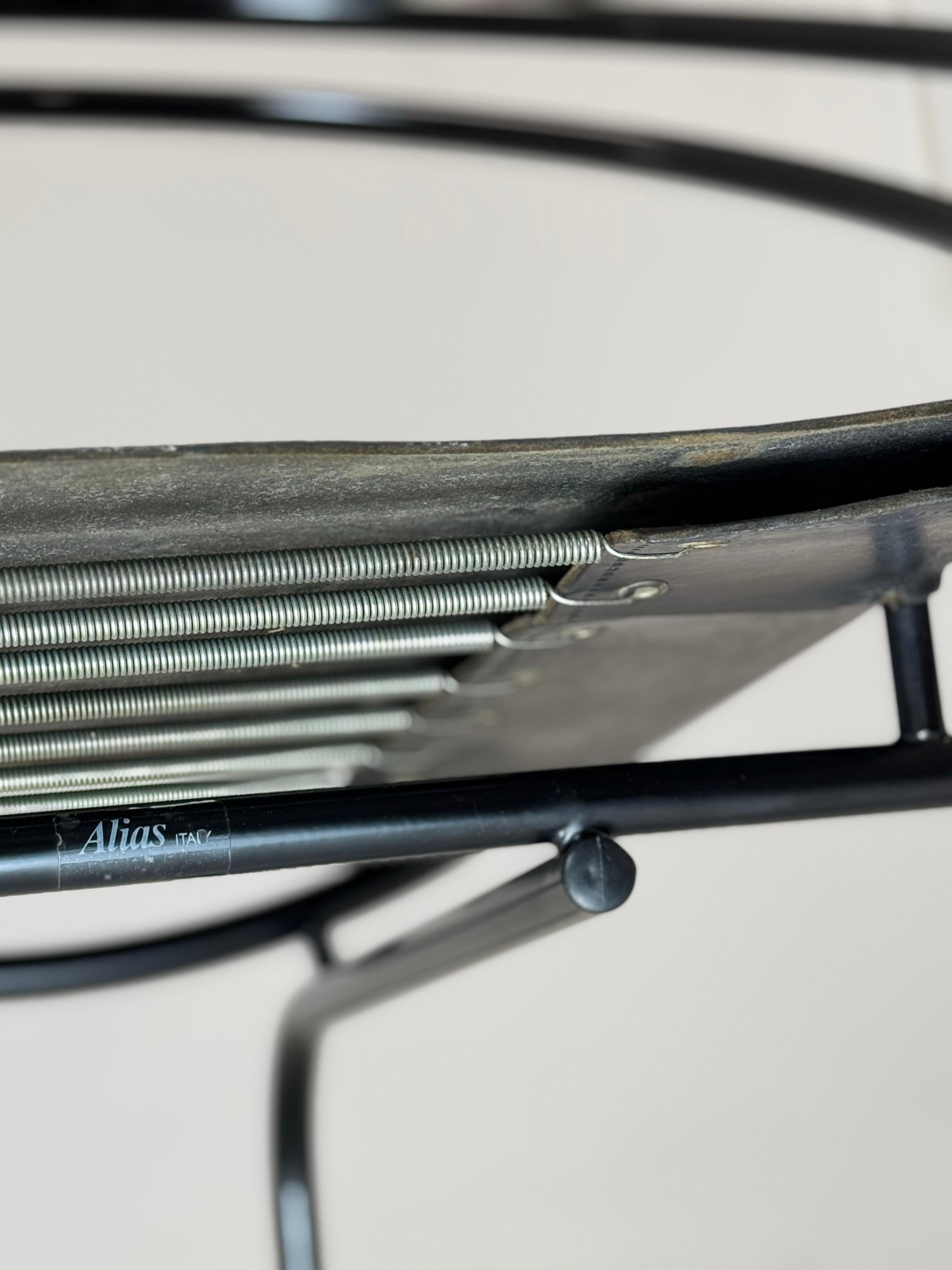 Latonda chair designed by Mario Botta for Alias, Italy 1987

The bent steel tube traces a fluid curve that gracefully moves through space. The two inclined circles, broken at the center, harmoniously embrace the leather seat, creating a refined