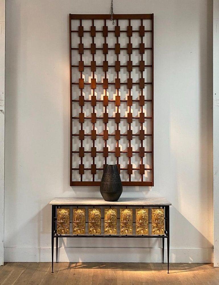 A wall hanging in wood of a striking lattice structure, with rectangles arranged geometrically on vertical and horizontal bars in a frame. A powerful decorative piece. 1960s, Spain.