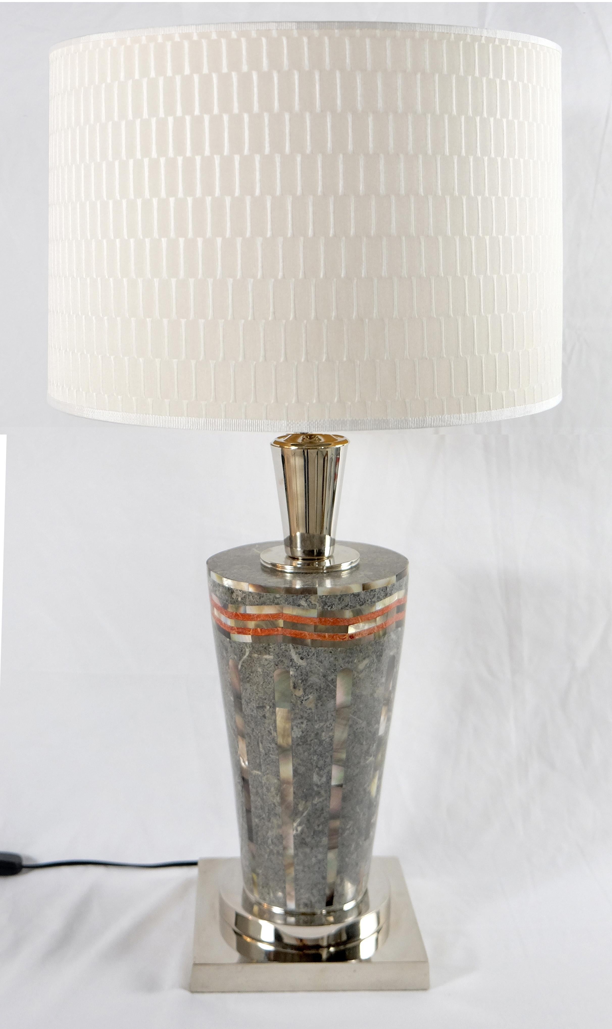 Laudarte Srl of Italy table lamp in marble and mother of pearl offered for sale is the Sintex table lamp with a sleek mosaic body of mother of pearl and stones from Ludarte Srl of Italy. The lamp is accented with brass details and completed with an