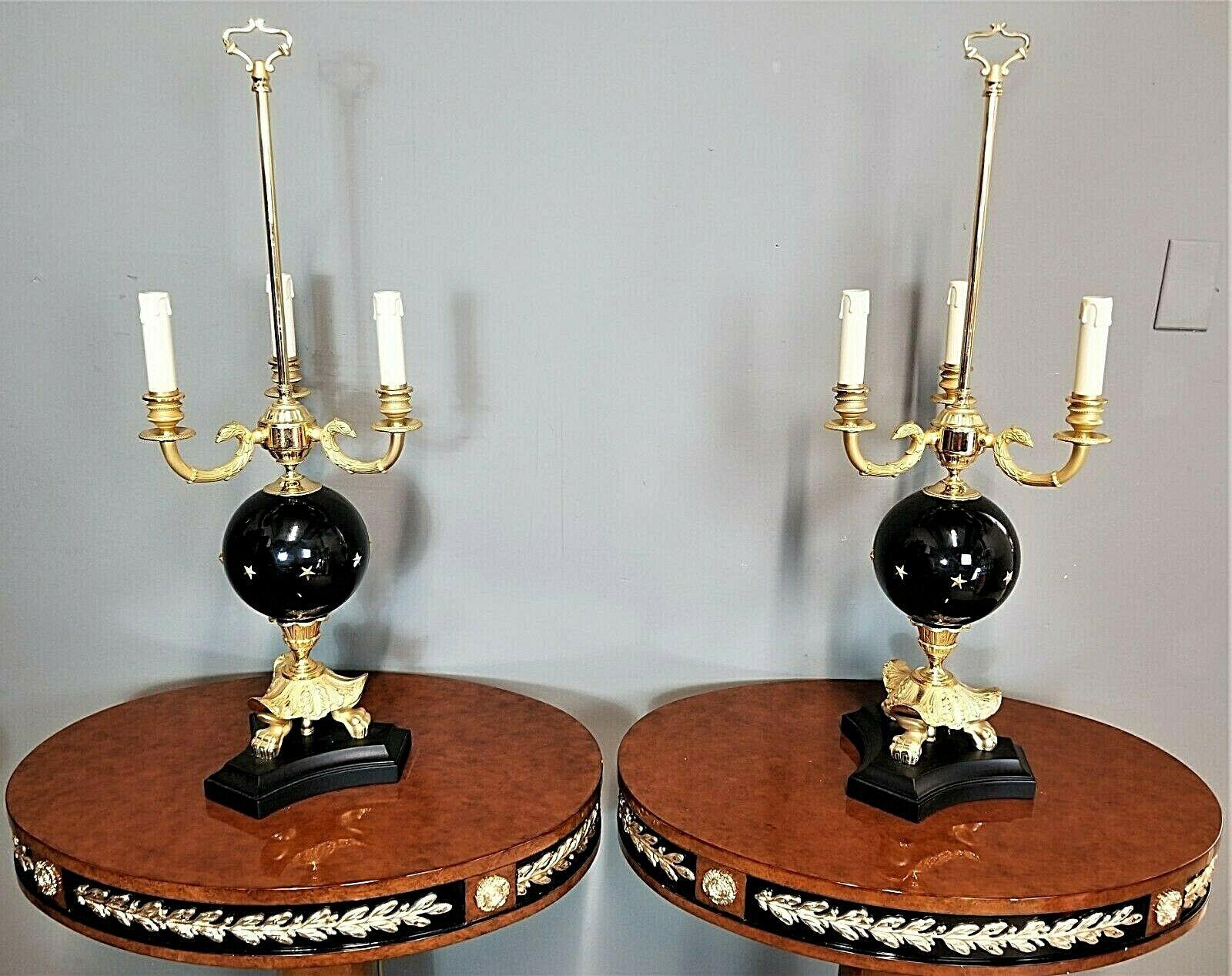 Offering One Of Our Recent Palm Beach Estate Fine Lighting Acquisitions Of A
Pair of LAUDARTE Gilt Versace Billouette Candelabra Table Lamps Made in Italy
Featuring gilt metal, black glass globes surrounded by gold stars and on wood bases.
They