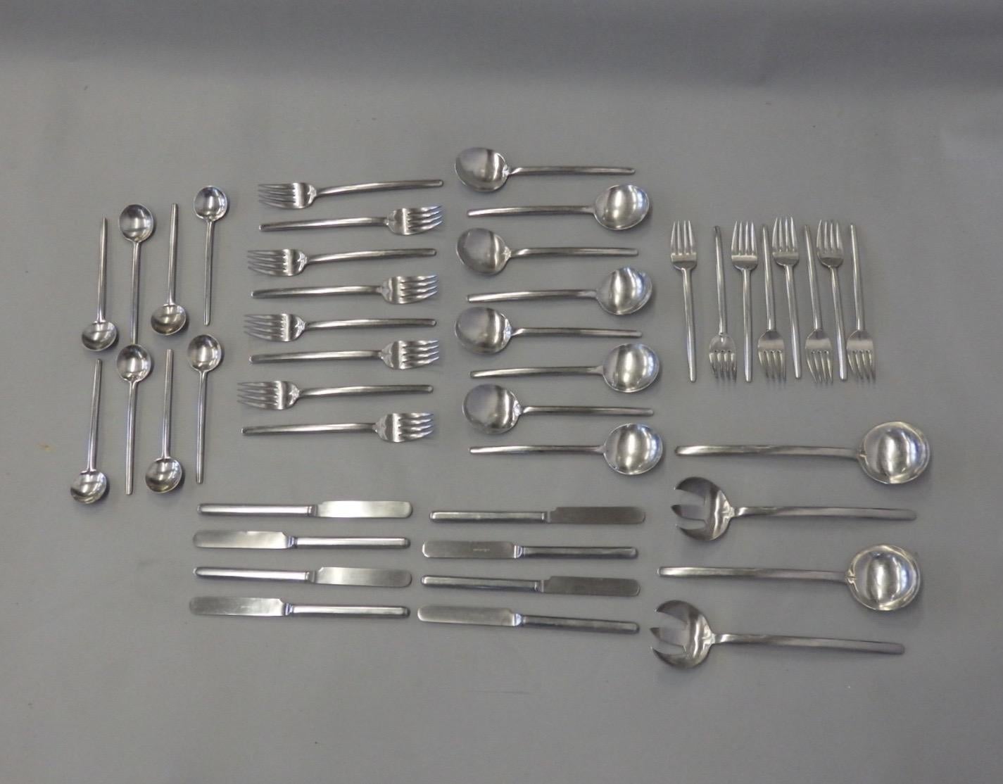 Marked Lauffer Holland 18/8 which denotes 18% chromium 8% nickel. The set is in good vintage condition . It has been used. Eight place settings of five pieces with four serving pieces 44 piece total.