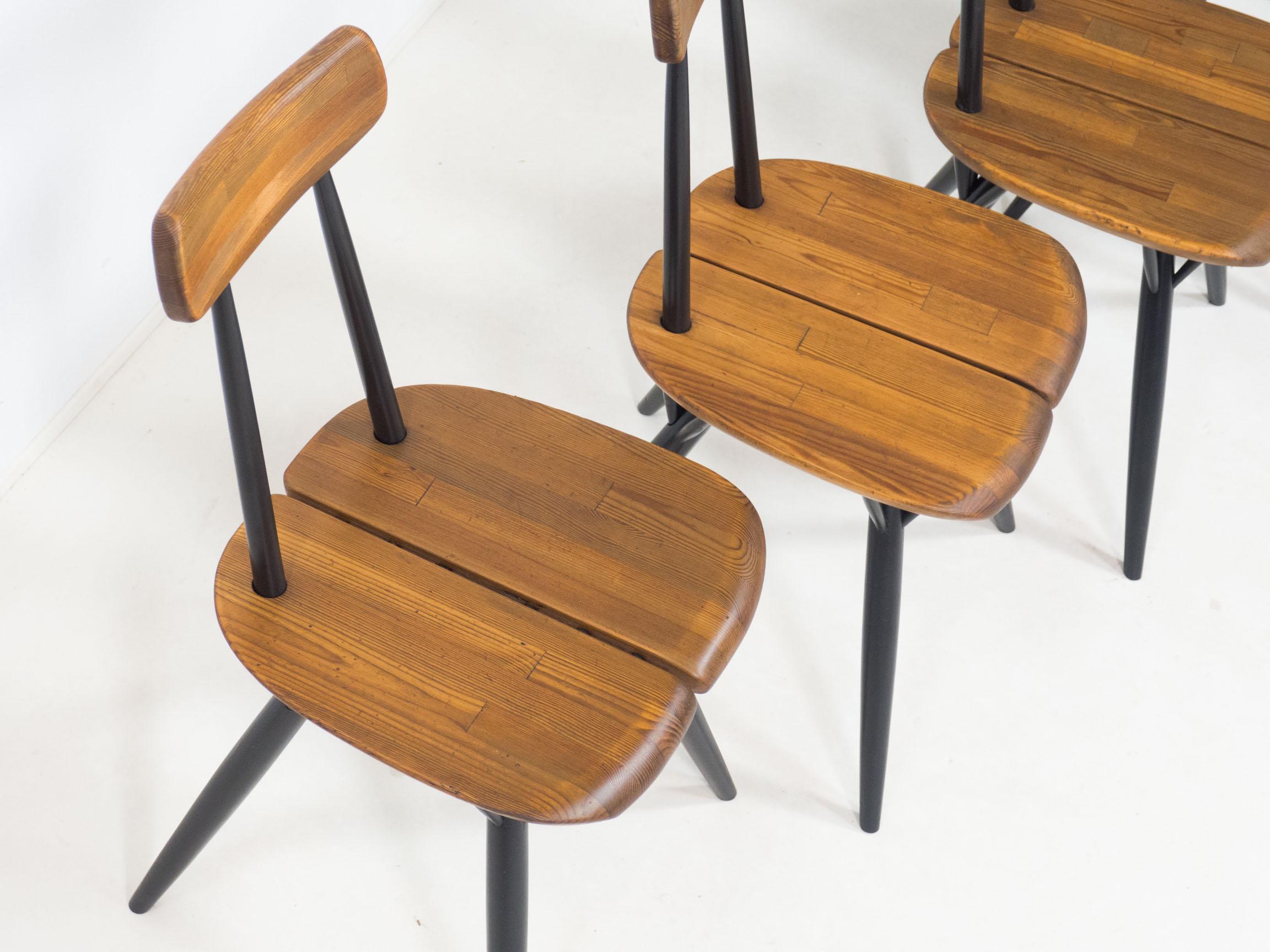 Set of four early Pirkka chairs designed by Ilmari Tapiovaara and manufactured by Laukaan Puu of Finlad in the 1950s.

These chairs are an iconic design and have seats and back rests made from several pieces of solid pine. The legs and back spokes