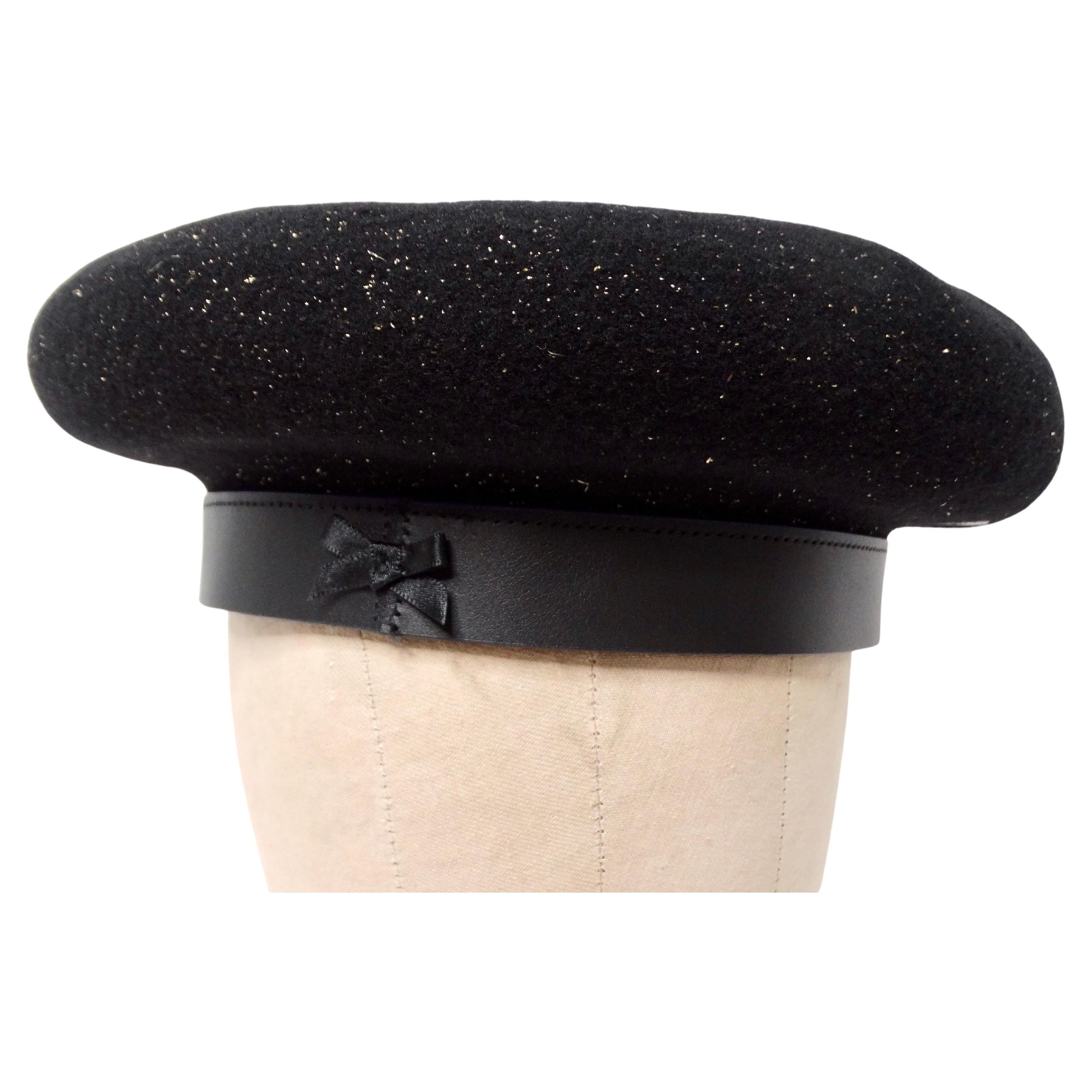 The Laulhere Black & Gold French Merino Wool Beret with Calfskin Leather Band is an exquisite accessory that effortlessly combines classic French elegance with modern luxury. Crafted from soft, high-quality black merino wool, the beret features