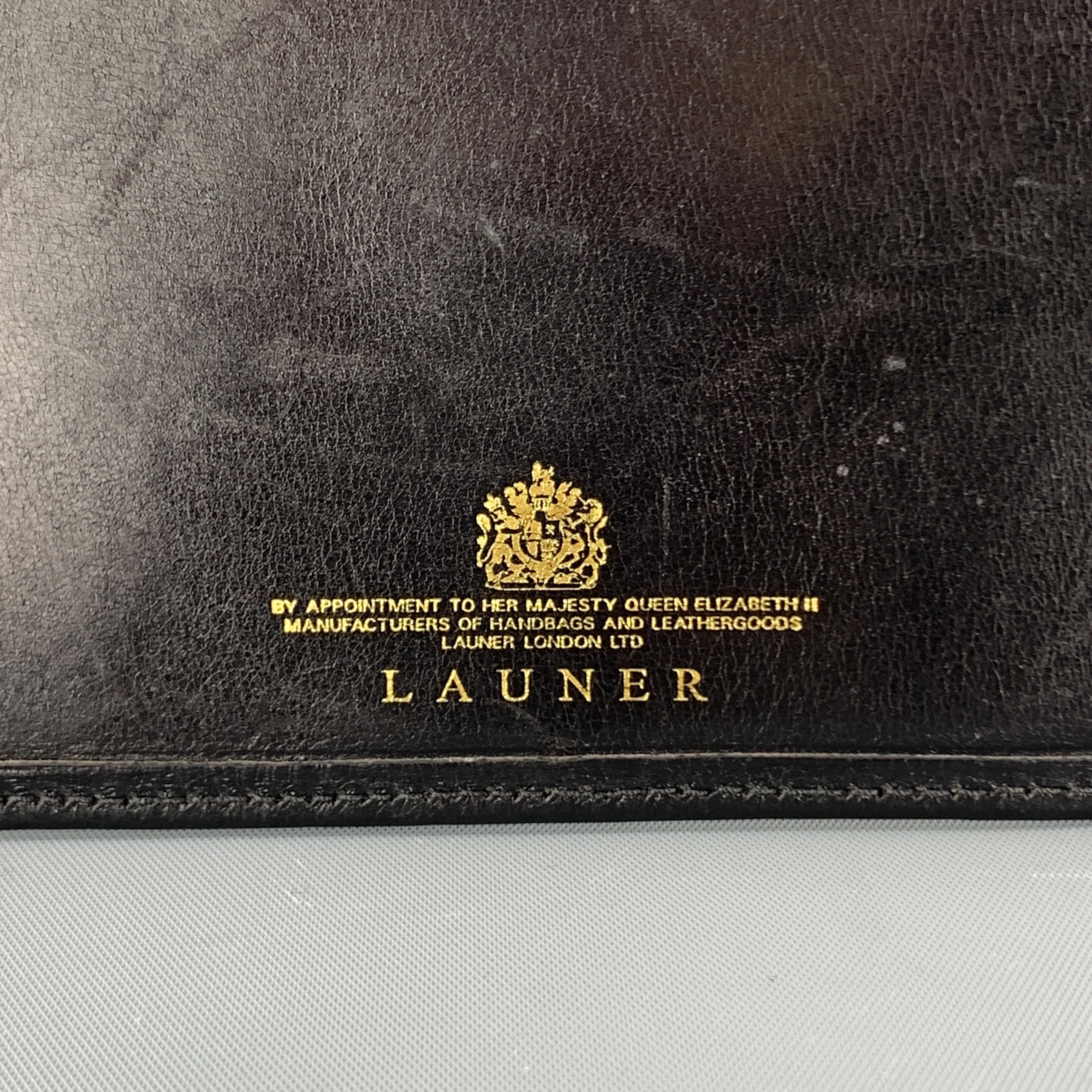 LAUNER card case comes in black leather with gold foil stamp. Made in England.

Very Good Pre-Owned Condition.

5.75 x 3.75 in.