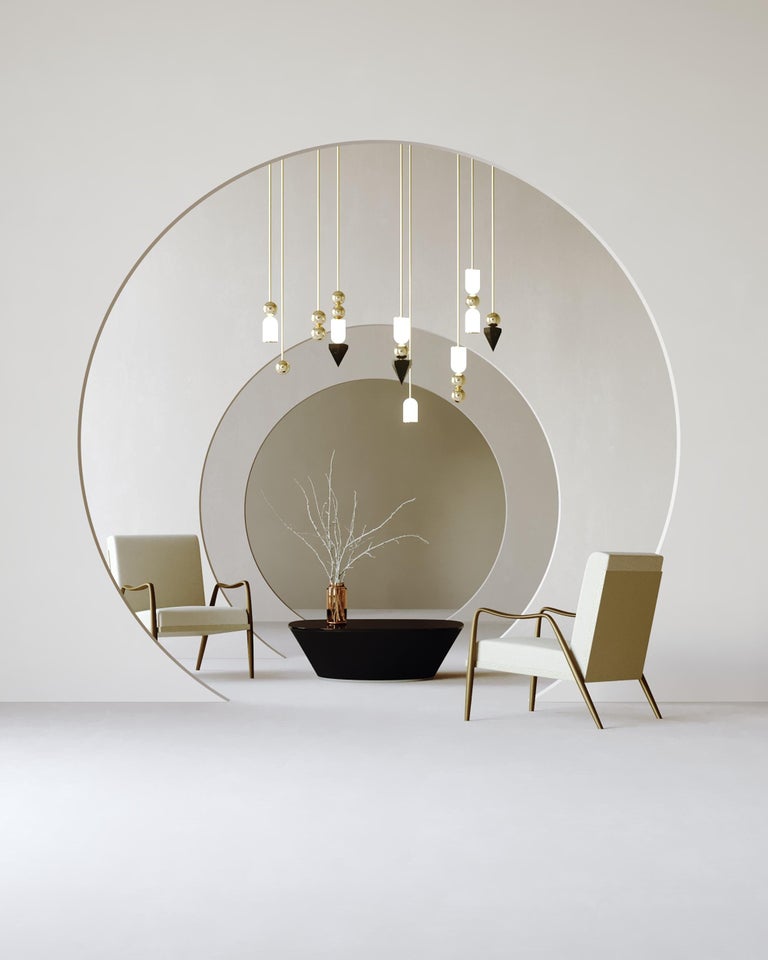 Inspired by the three states of matter, Laur combines semi-precious elements of brass, onyx, and hand blown white glass in playful interconnecting arrangements, some with functional LED light and others in complementary ornamental configurations.