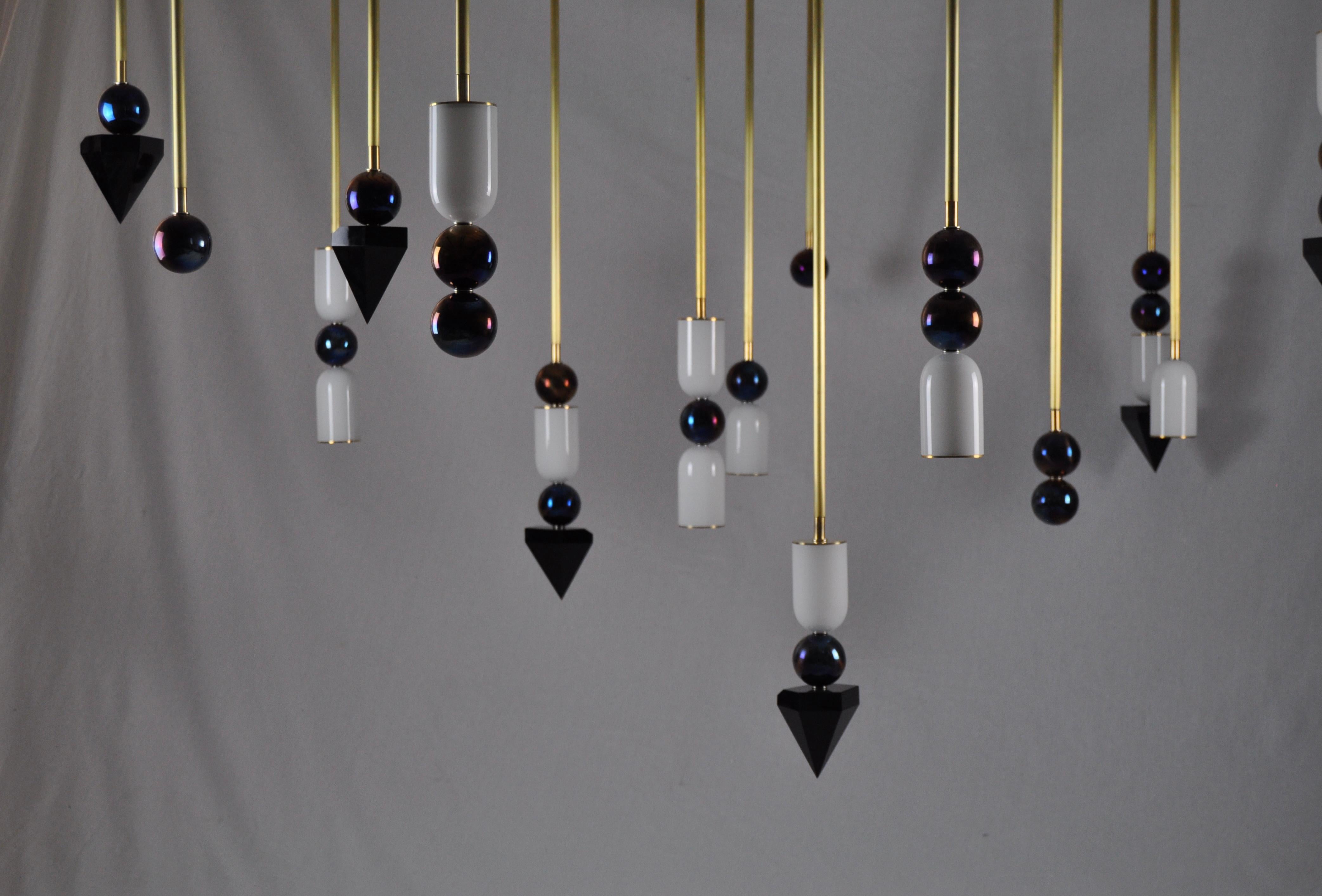 Inspired by the three states of matter, Laur combines semi-precious elements of brass, onyx, and hand blown white glass in playful interconnecting arrangements, some with functional LED light and others in complementary ornamental configurations.